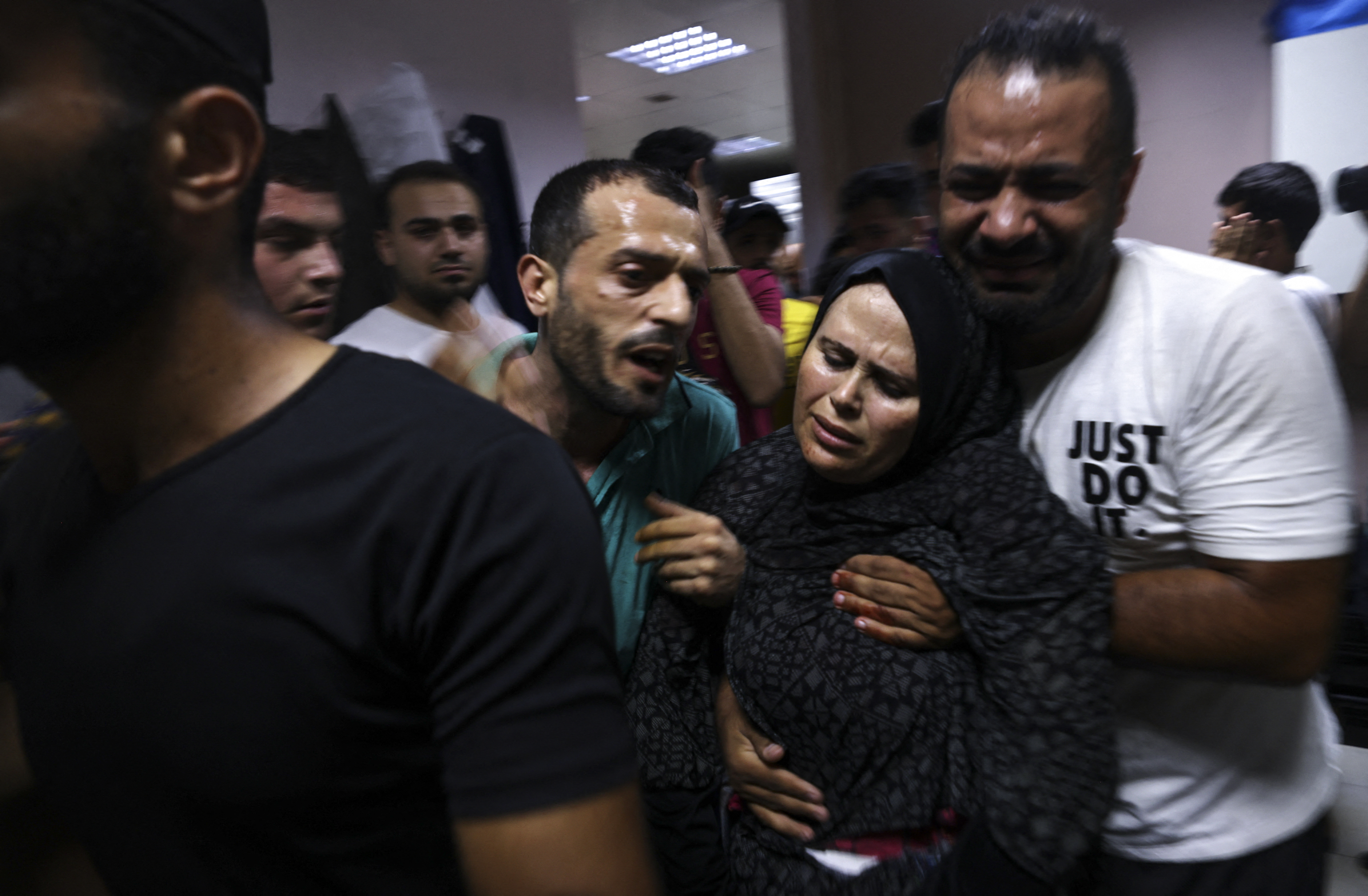 Palestinians react at a hospital in Jabalia refugee camp in the northern Gaza Strip