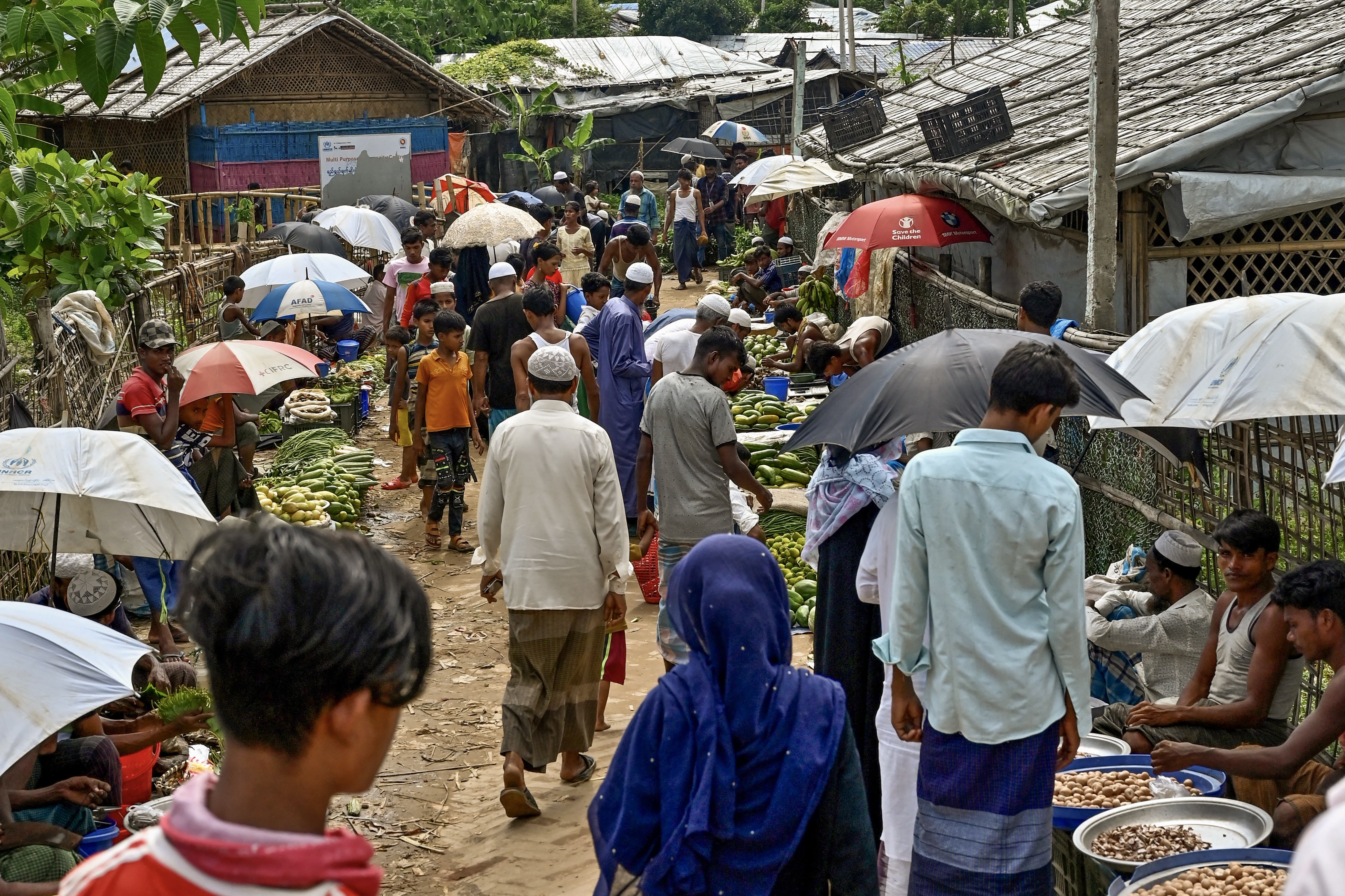 Rohingya refugees shop for vegetables and other essentials at a market area in Kutupalong refugee camp in Ukhia