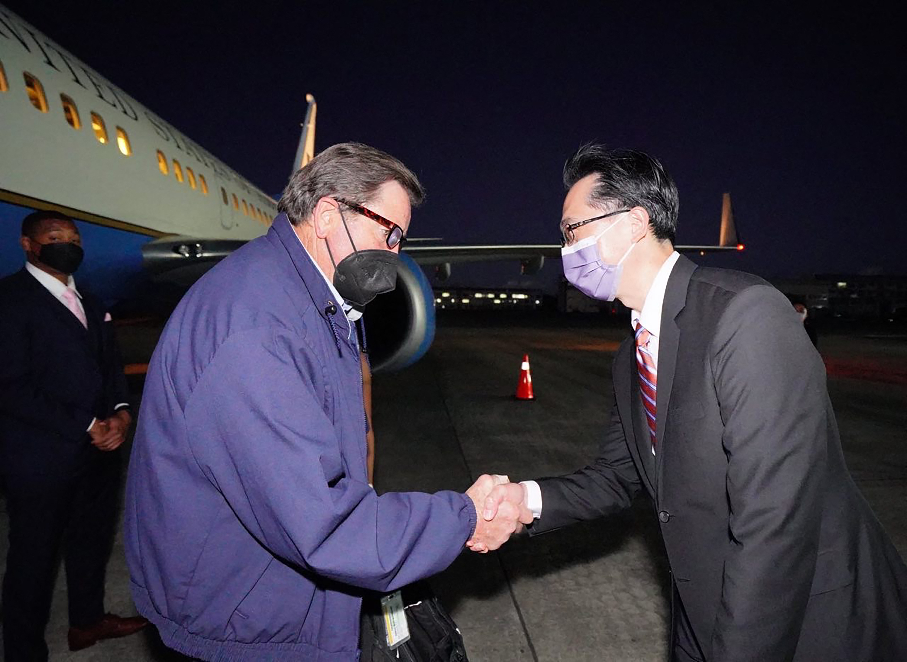 This handout picture taken and released by Taiwan's Ministry of Foreign Affairs (MOFA) on August 14, 2022 shows US Representative John Garamendi (L) shaking hands with Taiwanese diplomat Douglas Yu-tien Hsu