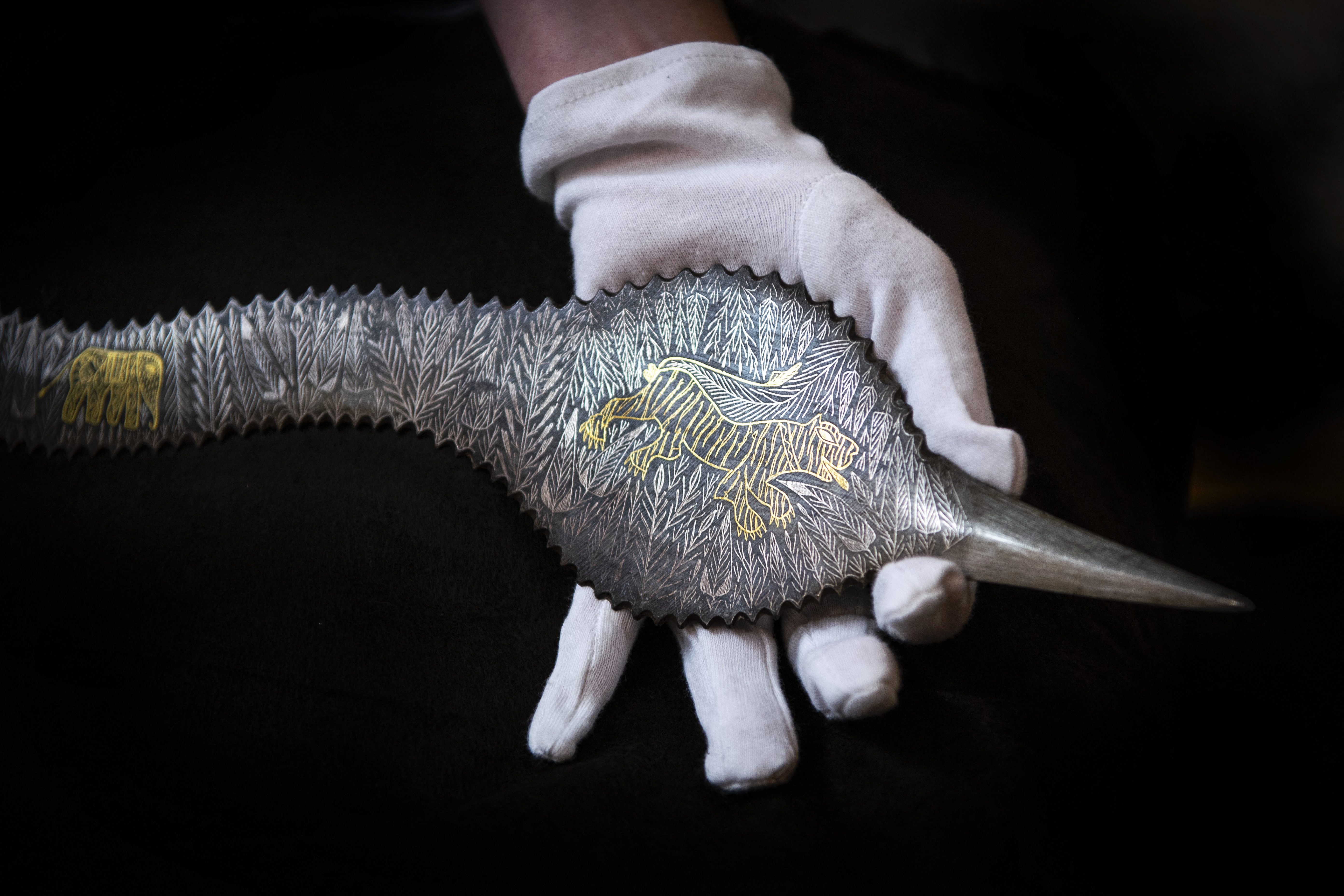 A ceremonial Indo-Persian sword is shown during a transfer of ownership ceremony