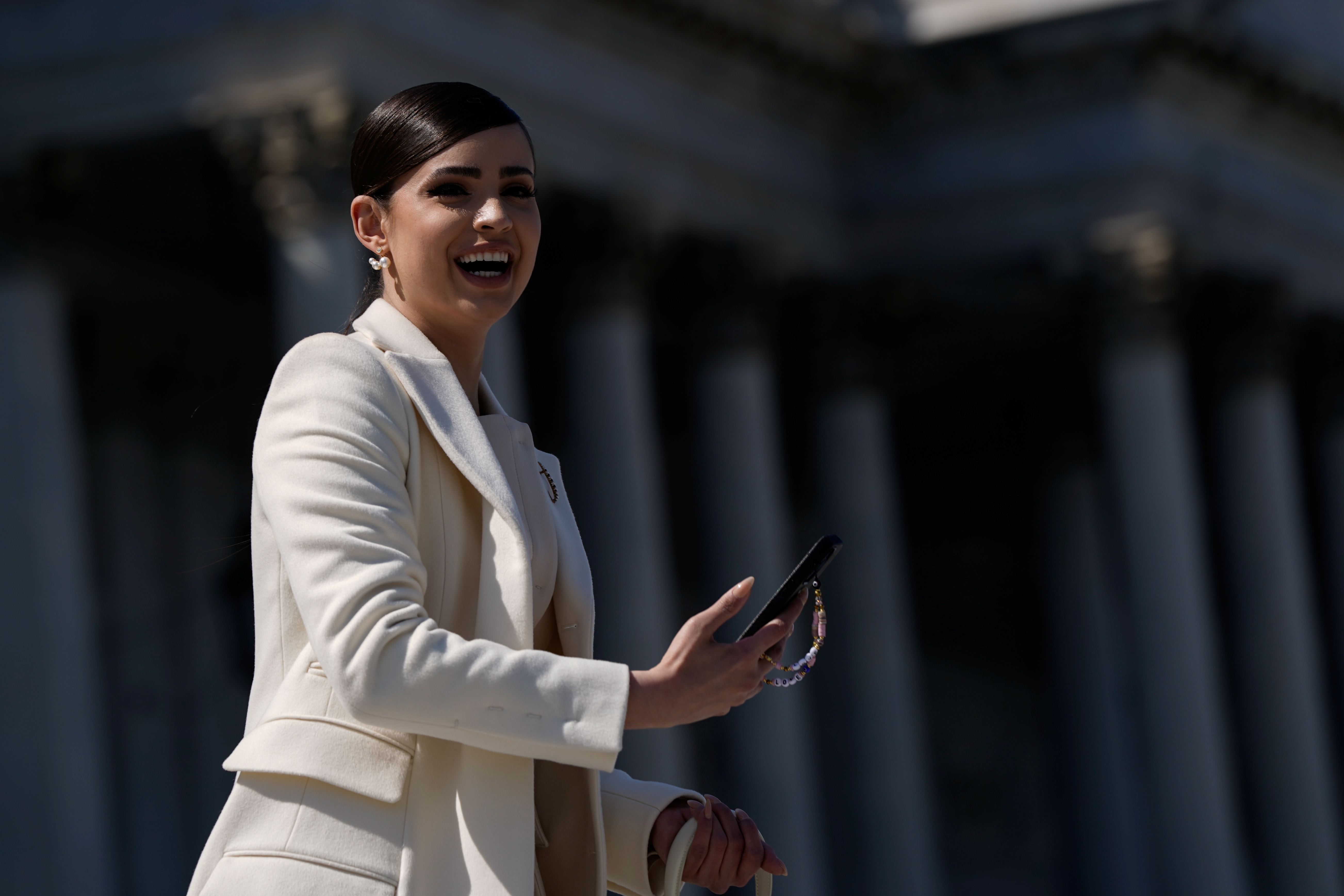 Actress and singer Sofia Carson, seen here on the steps of the US Capitol in April, plays a liberal young woman who ultimately embraces a more nationalistic politics in the Netflix film, Purple Hearts.