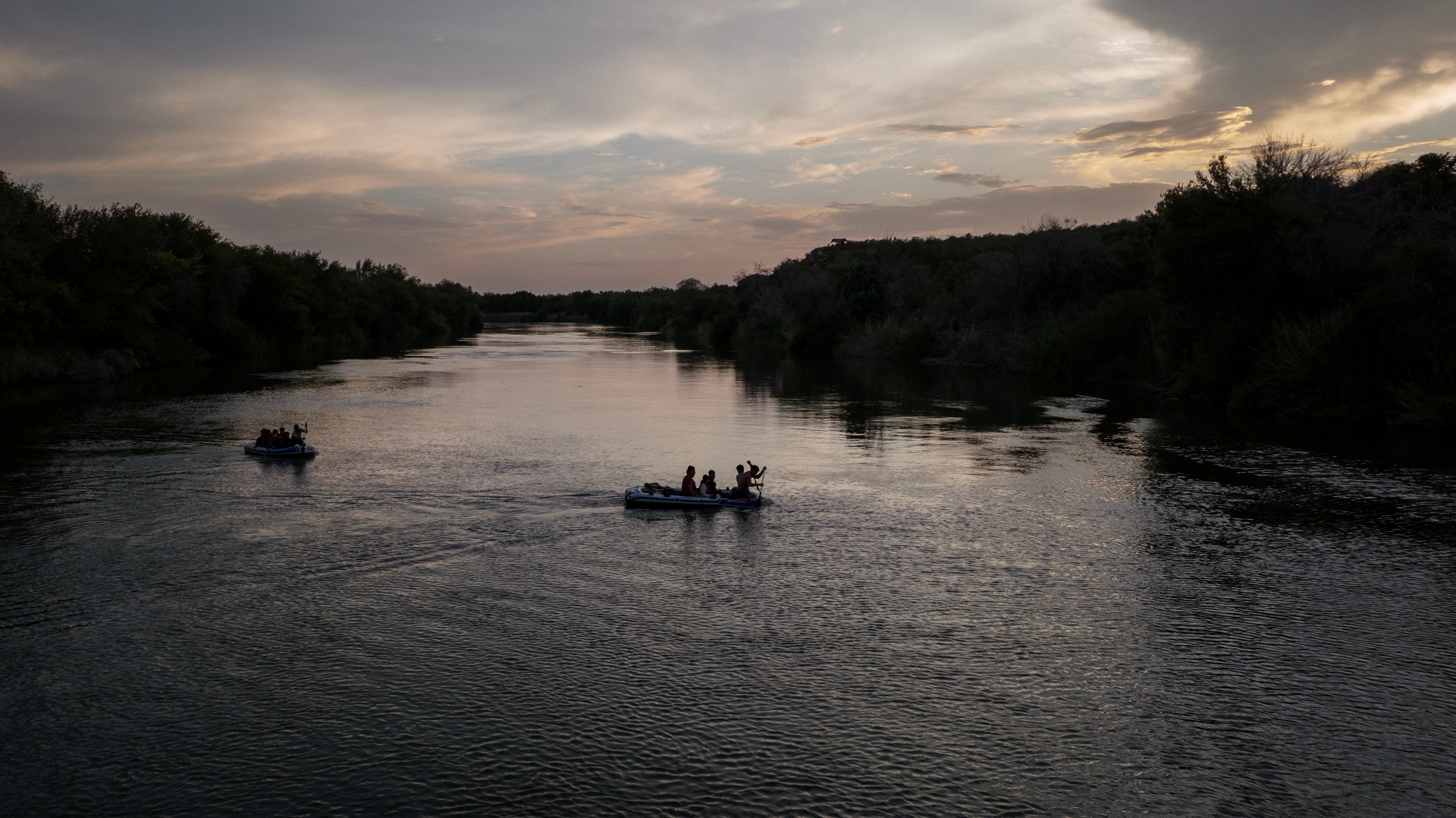 Smugglers use rafts to transport families across the Rio Grande river into the US from Mexico