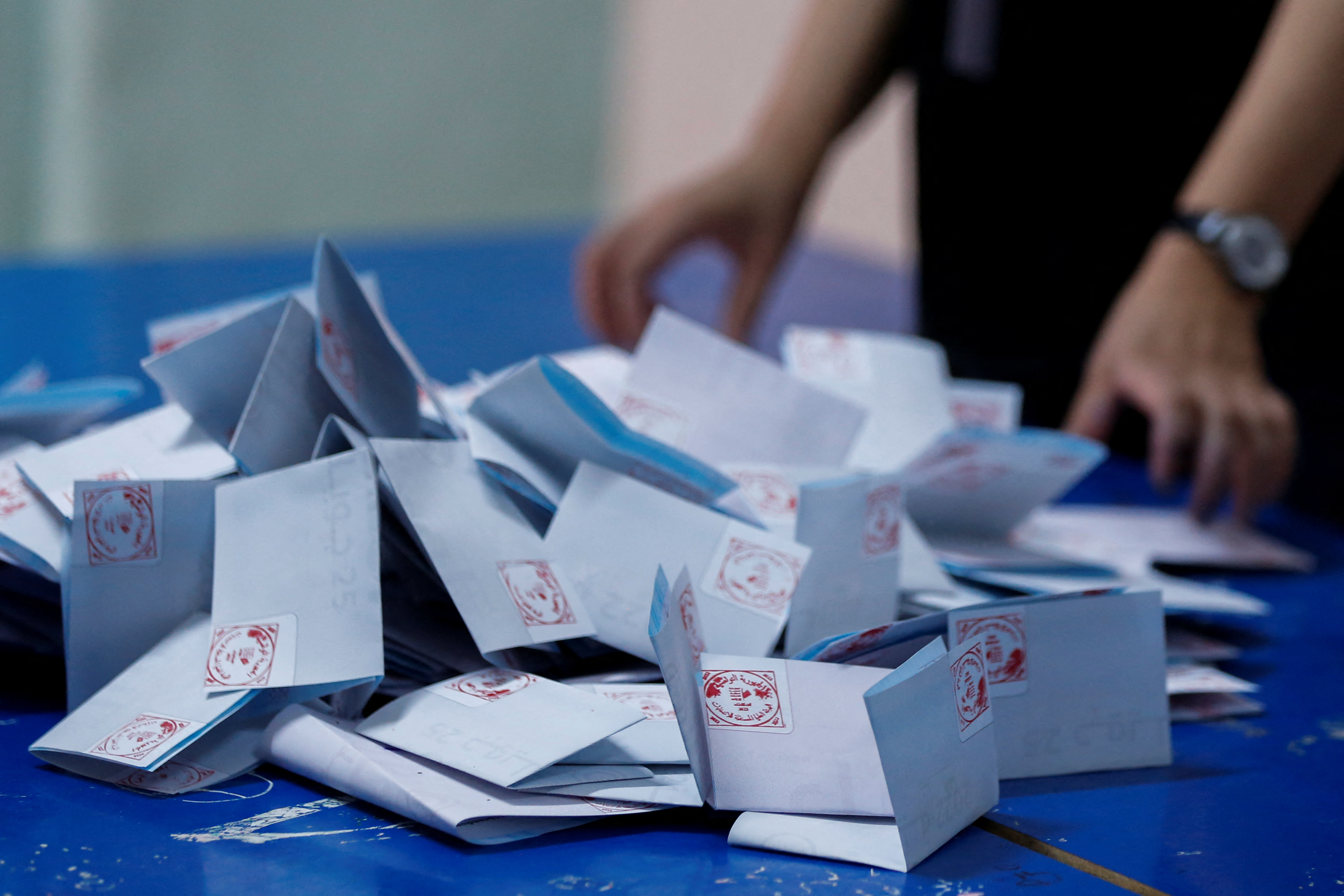 A member of the election committee counts votes at a polling station during a referendum on a new constitution in Tunis, Tunisia July 25, 2022.