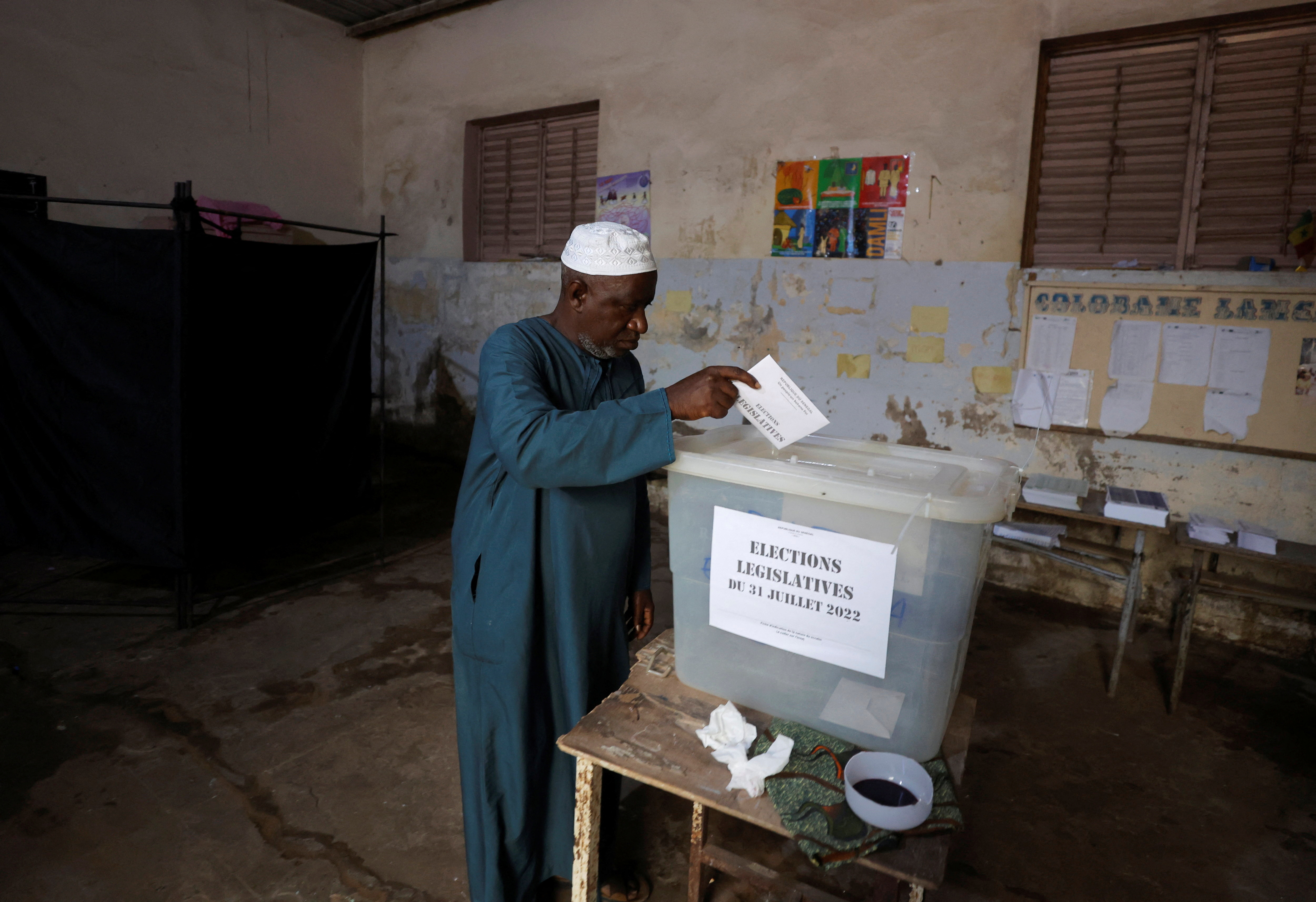 A man casts his ballot during the parliamentary election, in Pikine, on the outskirts of Dakar, Senegal.