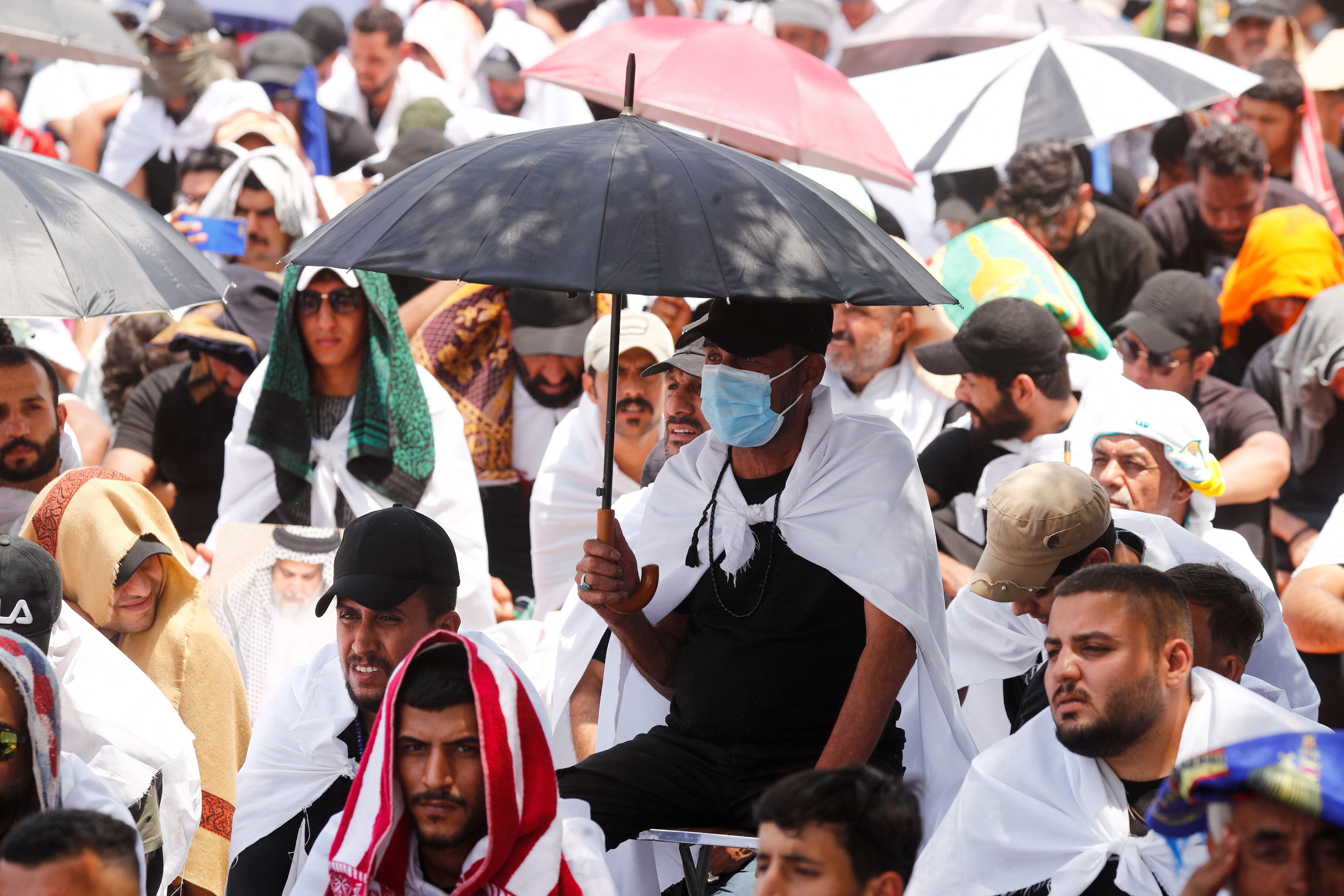Supporters of Moqtada al-Sadr gather for mass Friday prayer at Grand Festivities Square within the Green Zone, in Baghdad, Iraq on August 5, 2022 [Thaier Al-Sudani/Reuters]