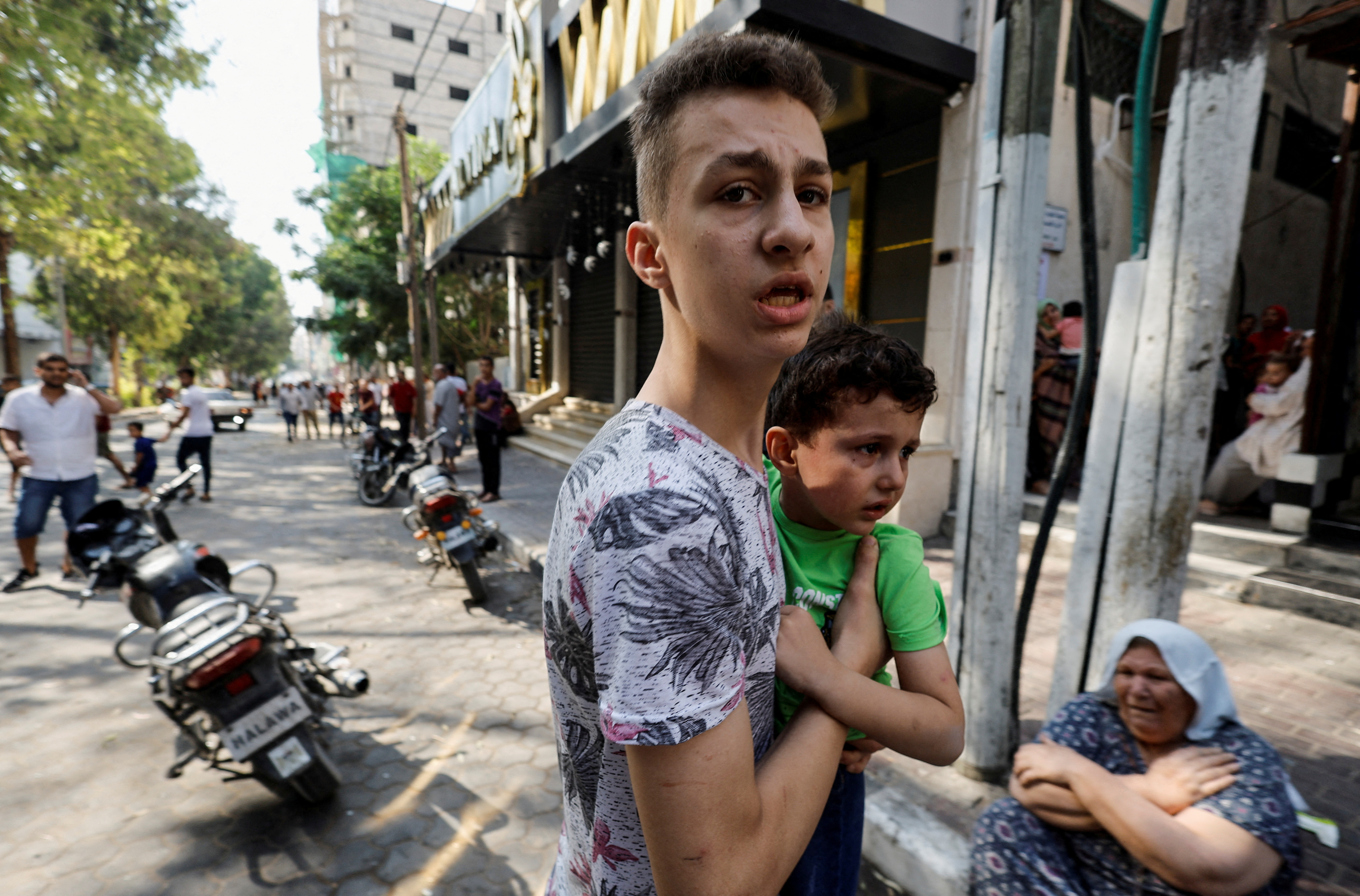 Palestinians children at the site of an explosion, following Israeli strikes in Gaza City, August 5, 2022 [Mohammed Salem/Reuters]