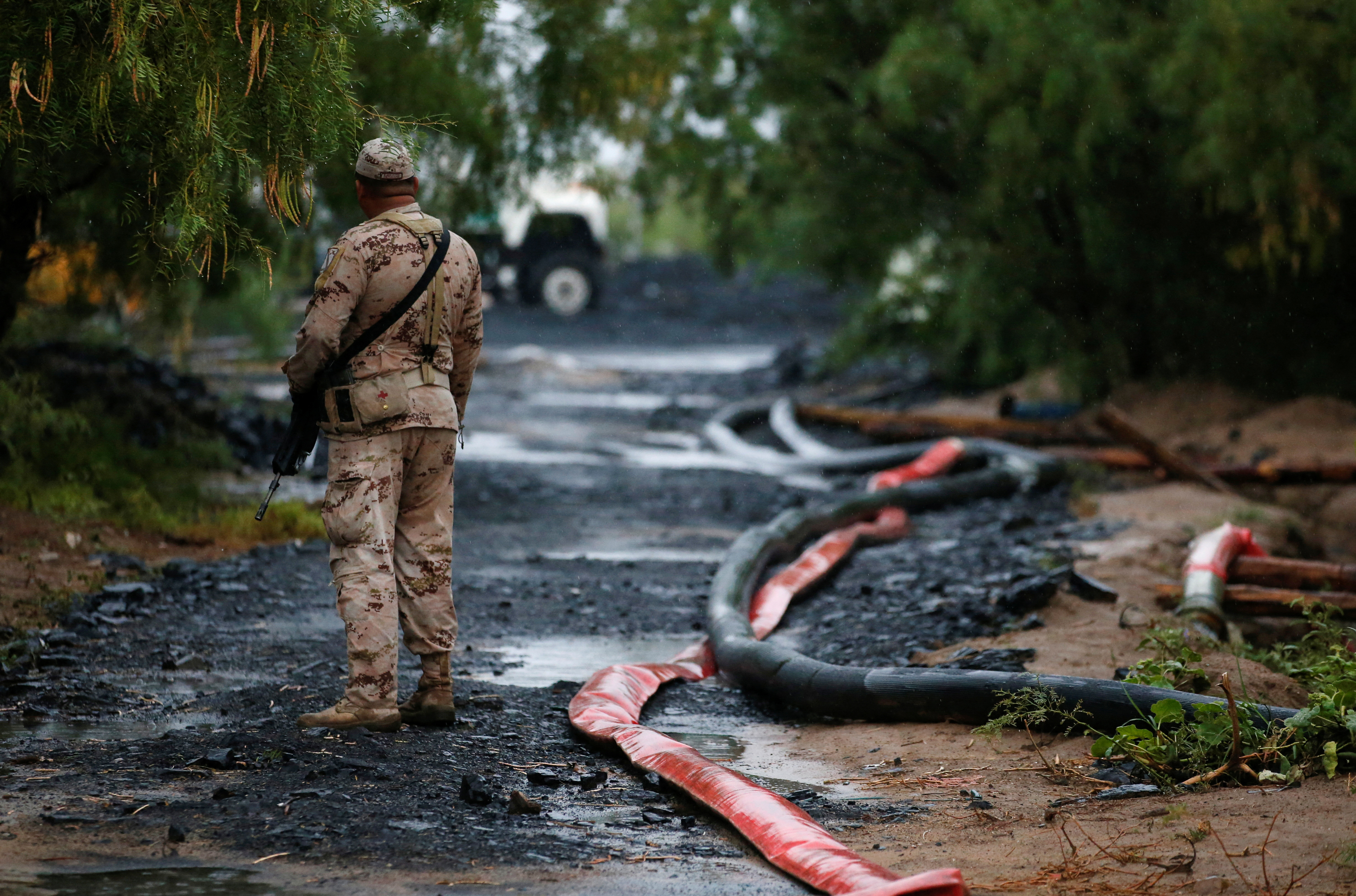 A soldier stands guard in area of collapsed mine in Mexico