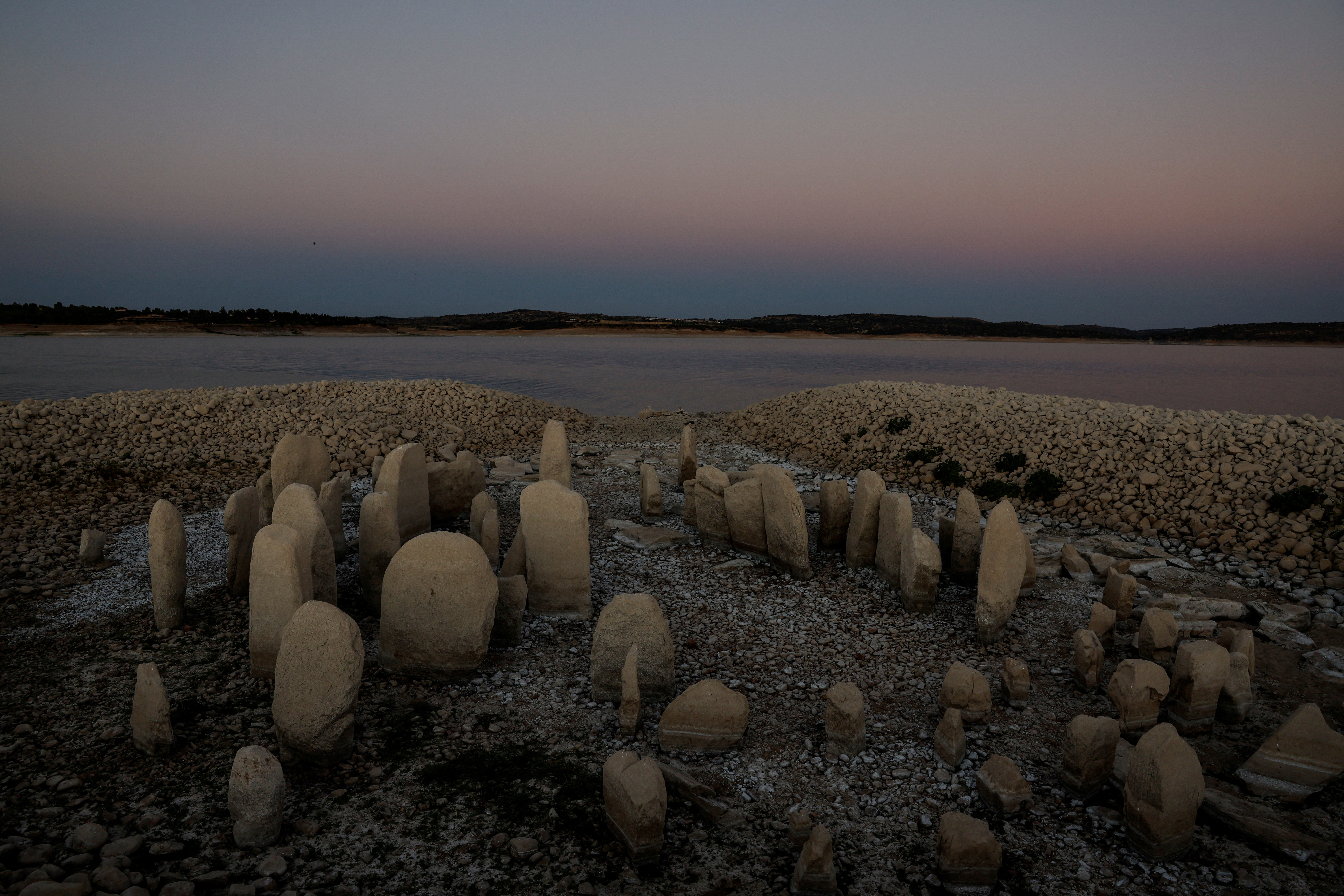 The dolmen of Guadalperal, also known as the Spanish Stonehenge, is seen due to the receding waters of the Valdecanas reservoir in the outskirts of El Gordo, Spain [File: Susana Vera/Reuters]