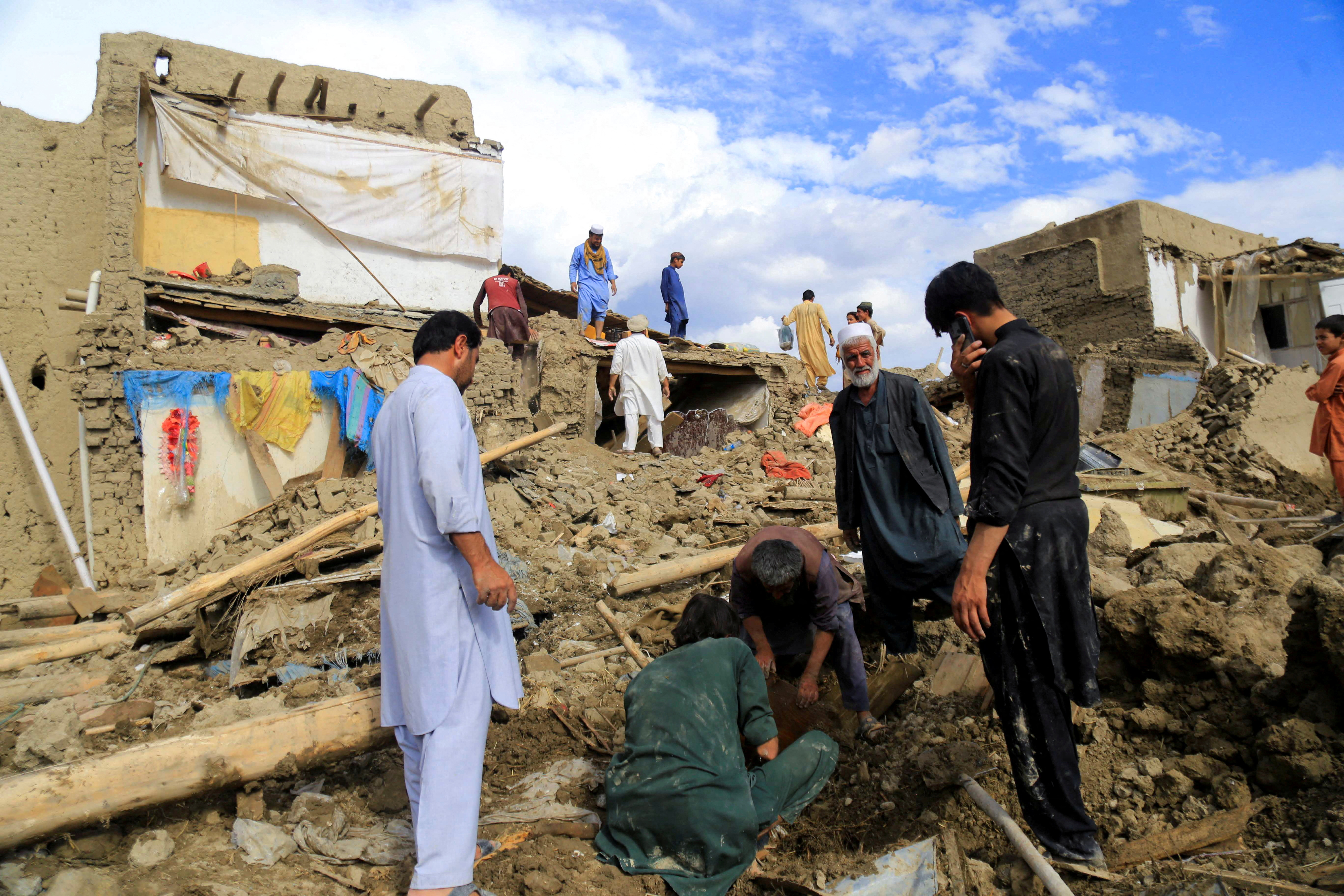 People clean up their damaged homes