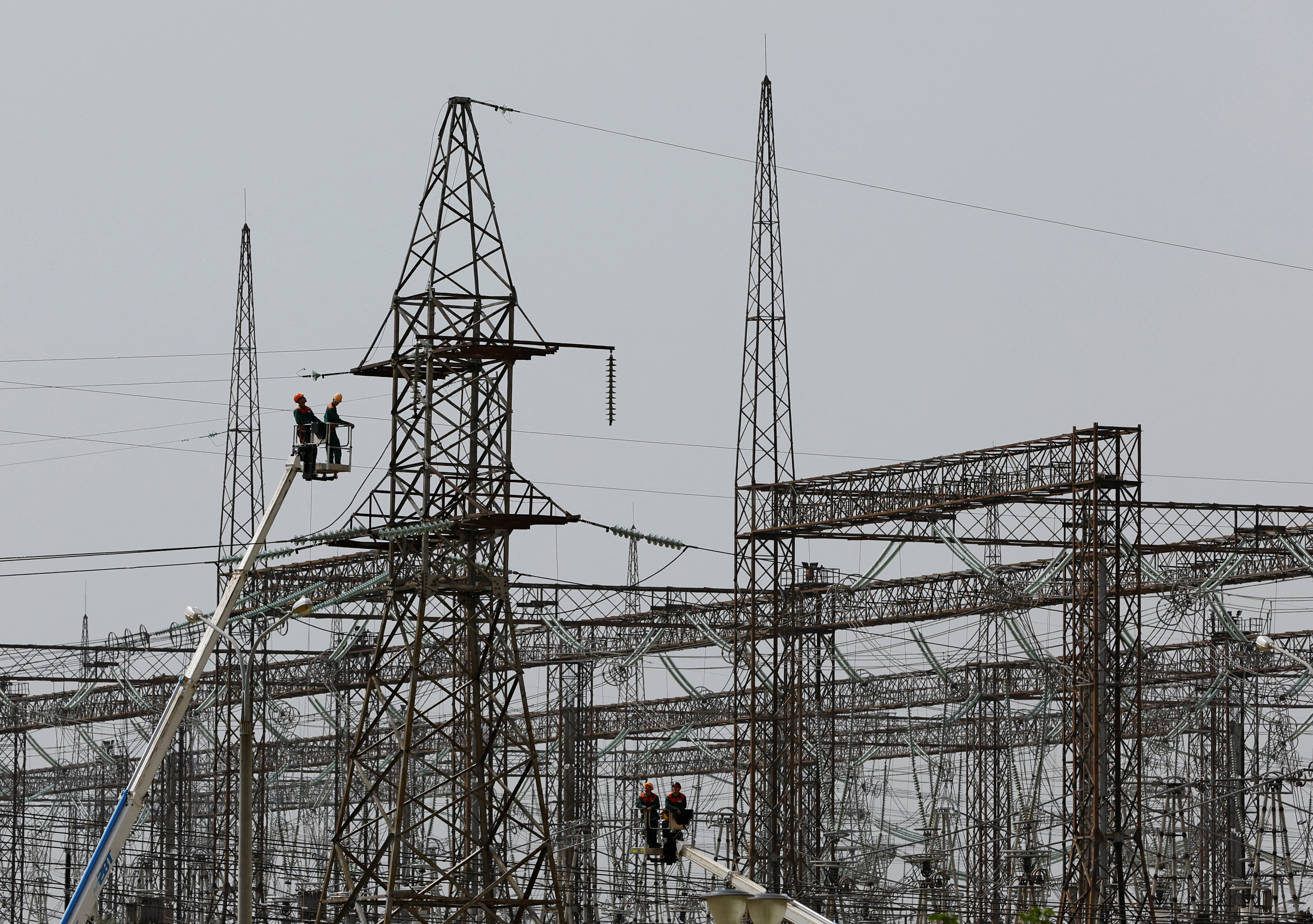 Employees work on electricity networks near the Zaporizhzhia Nuclear Power Plant.