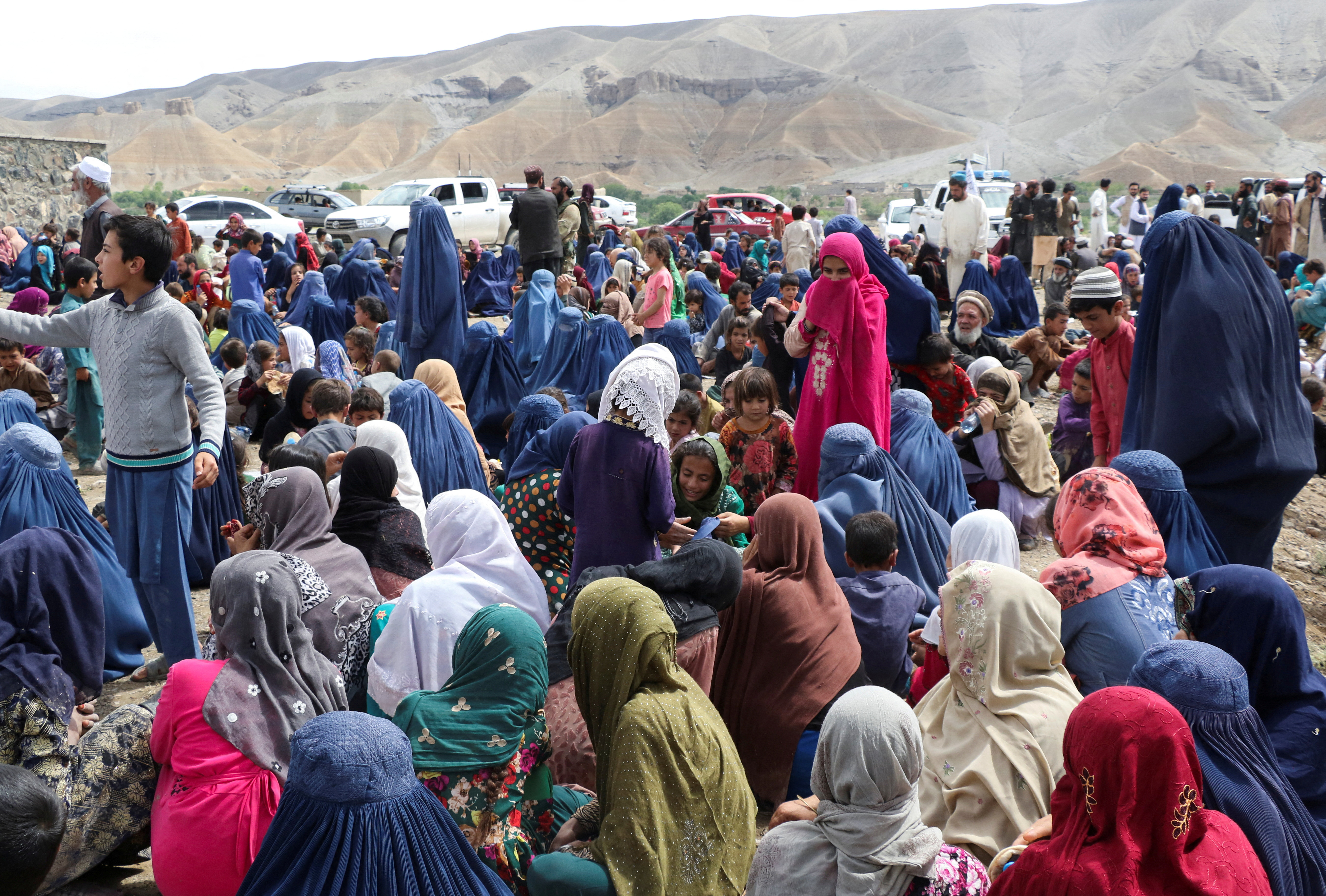 Displaced Afghan families spend time together after the heavy flood in the Khushi district of Logar province [Reuters]