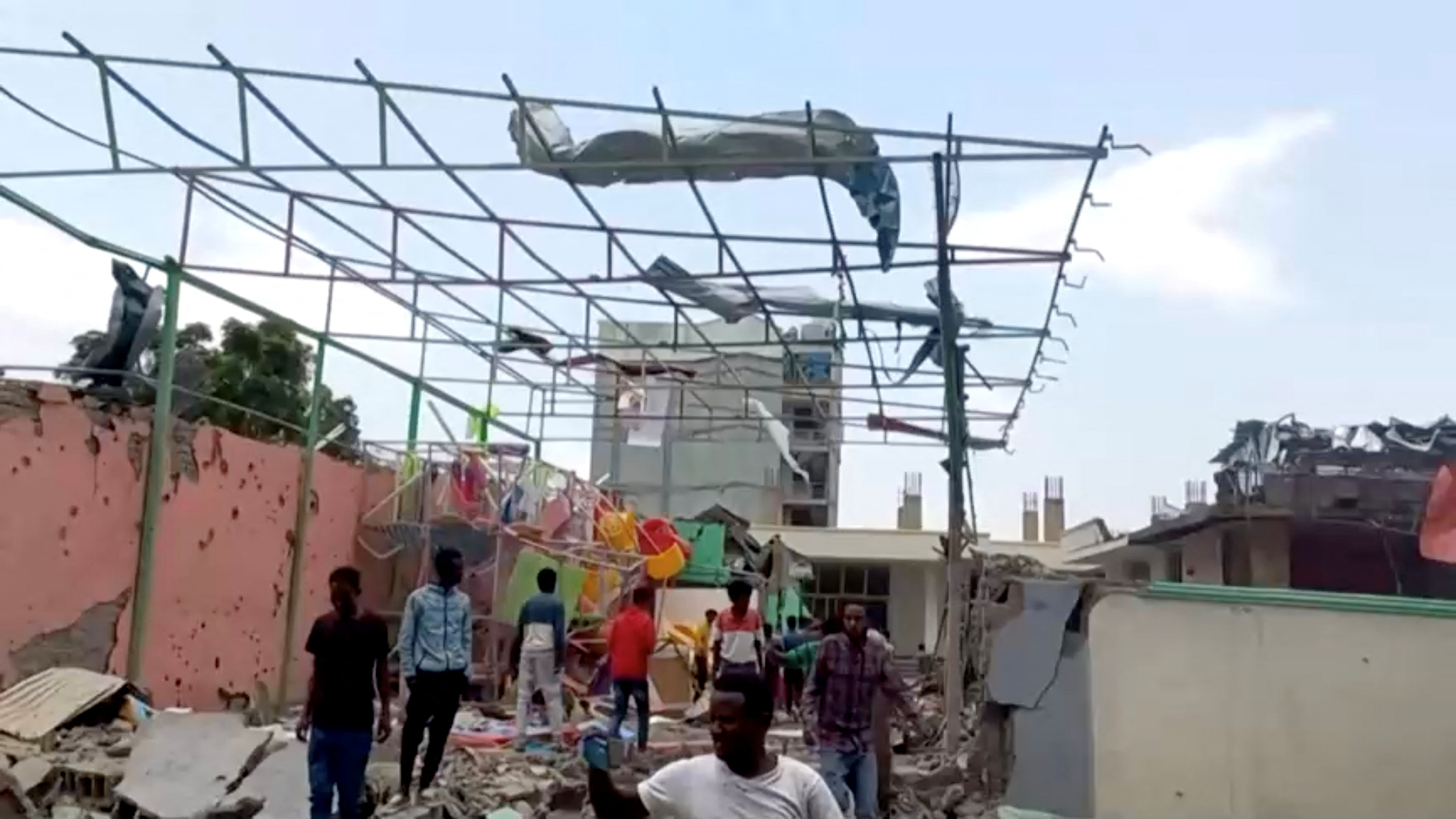 People inspect a damaged playground following an air strike in Mekelle.