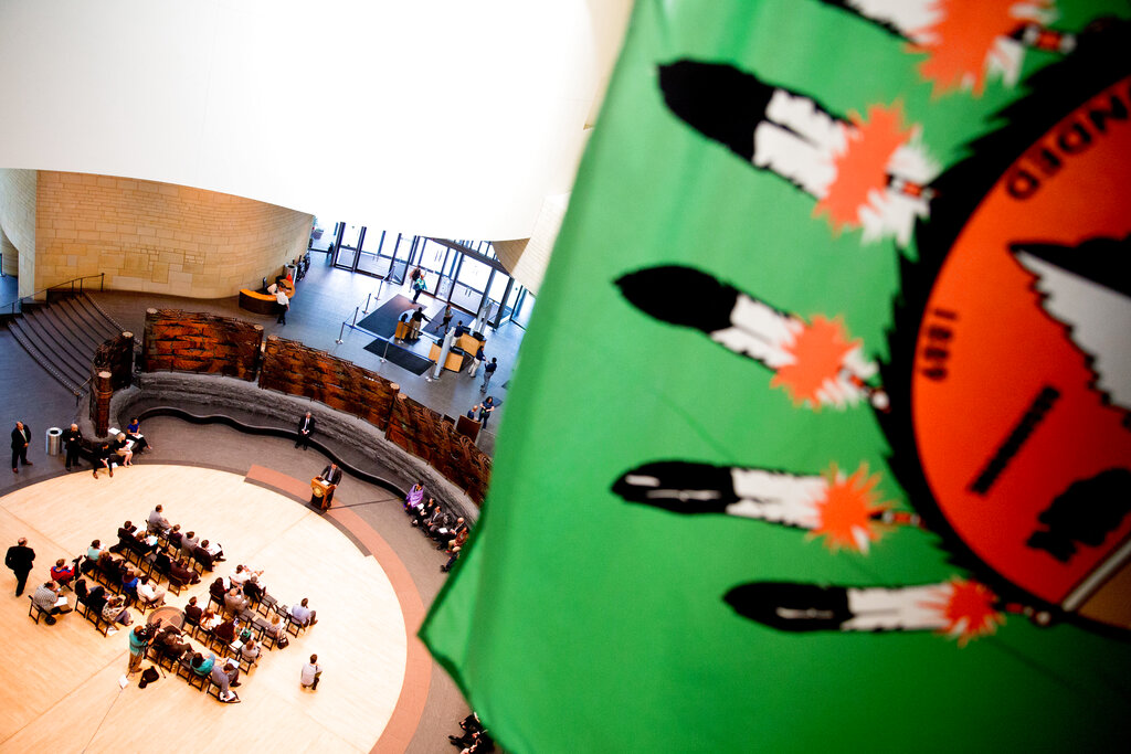 A Native American flag hangs above American Indian Nations and American Indian advocates as they hold a press conference in Washington in 2016