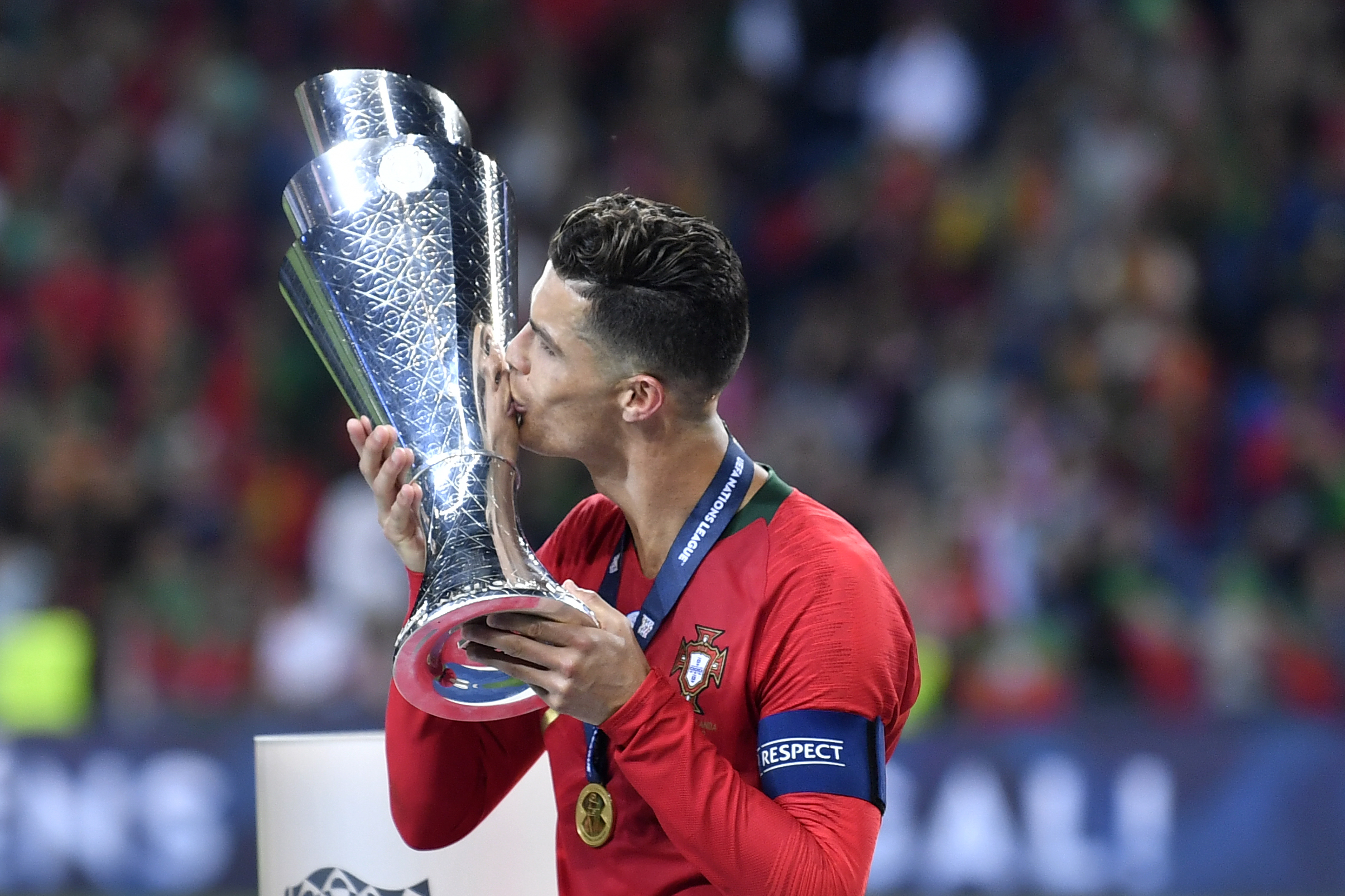 Portugal's Cristiano Ronaldo kisses the trophy