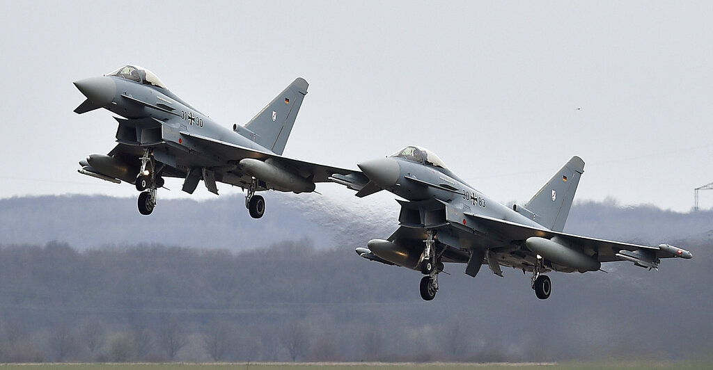 Two Eurofighter jets perform at the German Air Force Base in Noervenich, western Germany. [File: Martin Meissner/AP]