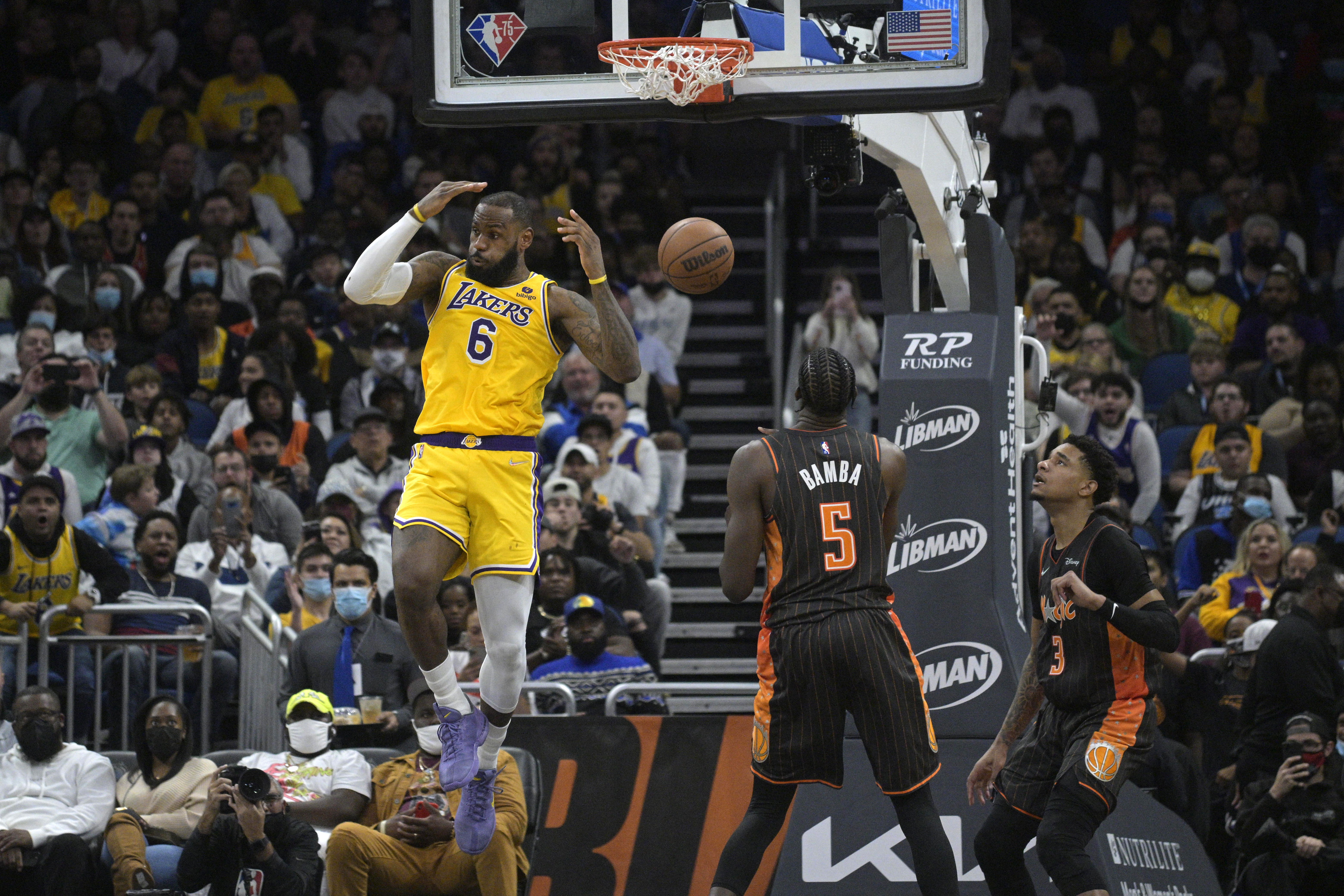 LeBron James jumps by the basket