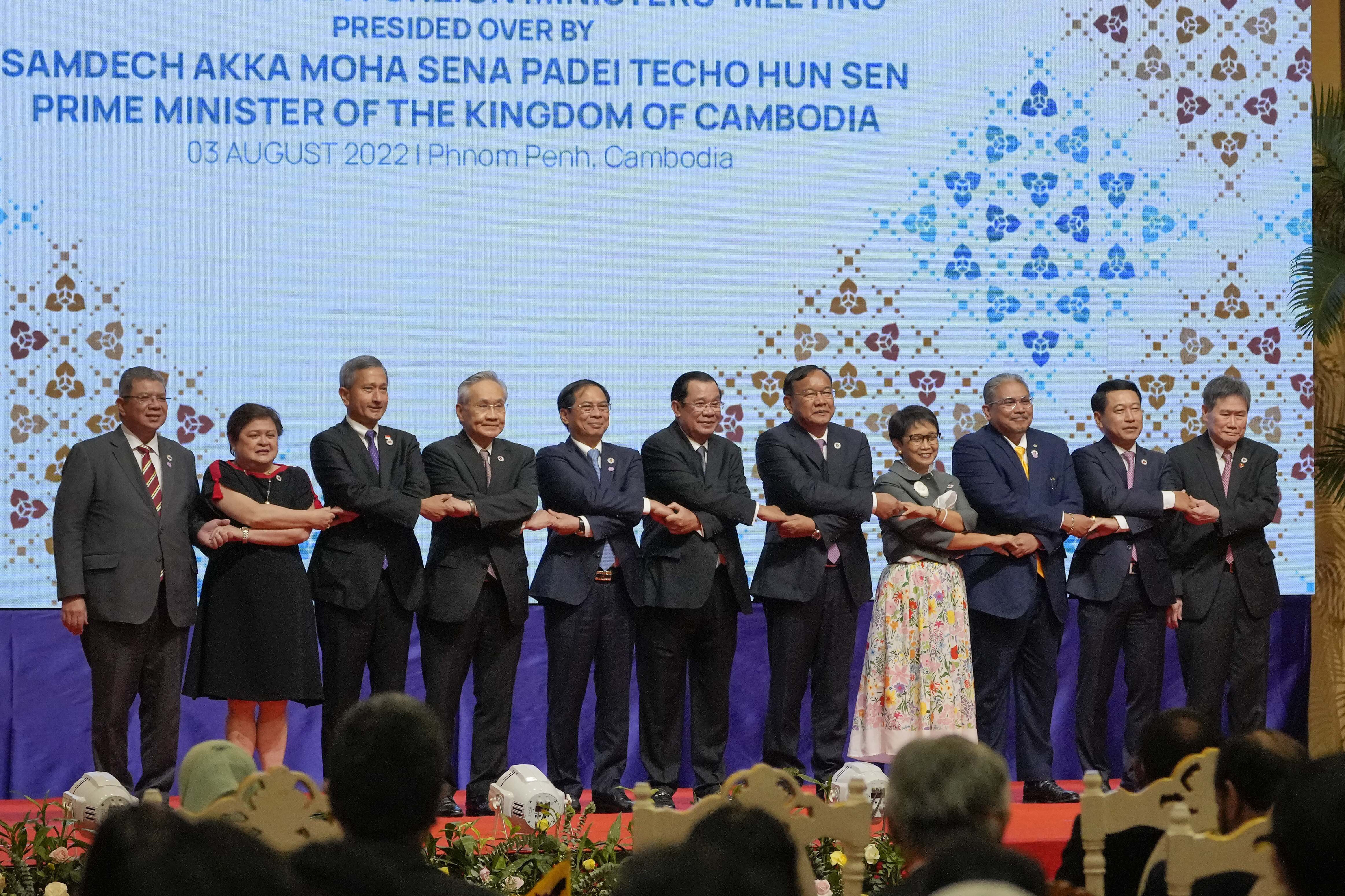 Asean foreign ministers standing on stage at their meeting in Phnom Penh