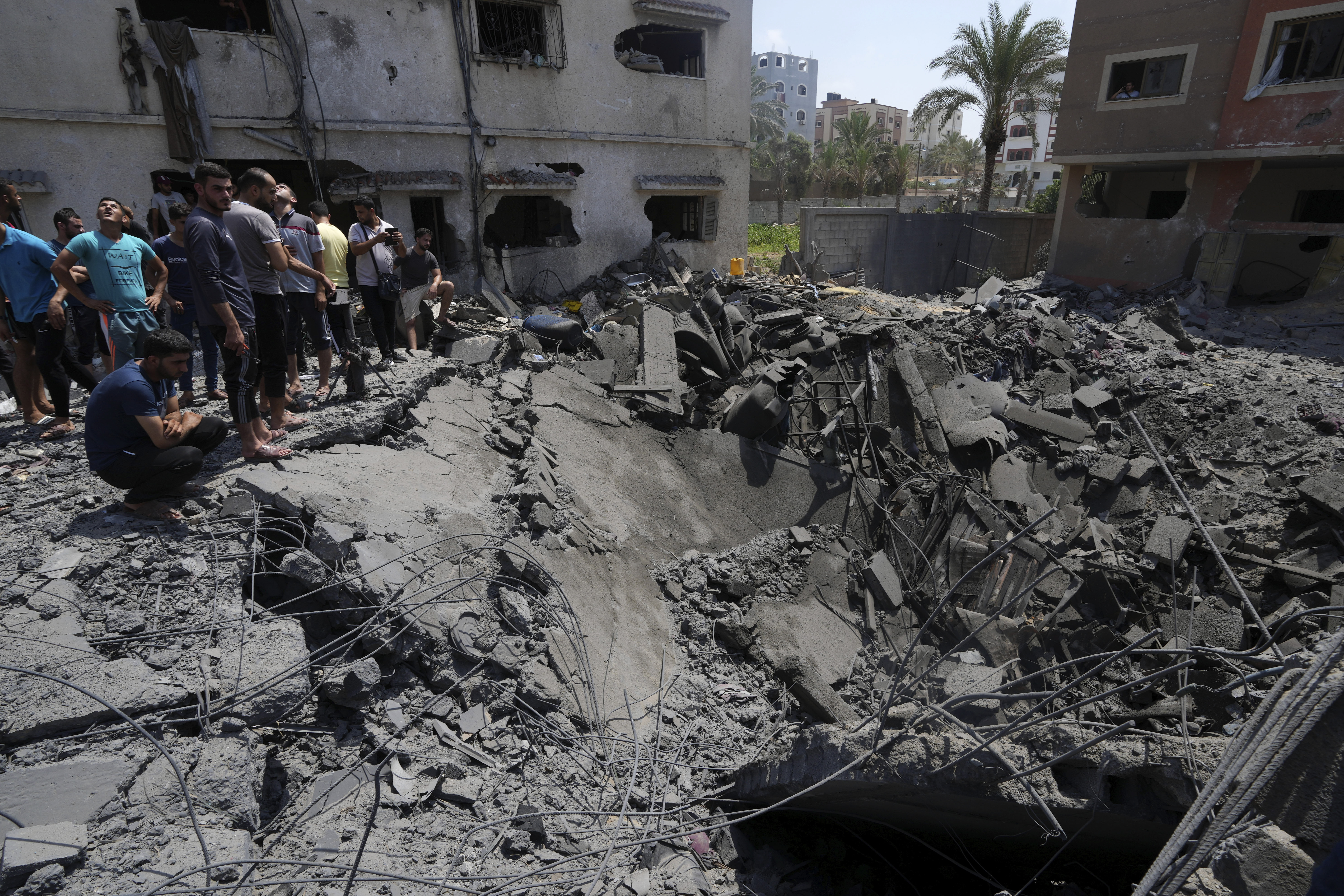 Residents inspect the rubble of destroyed residential building