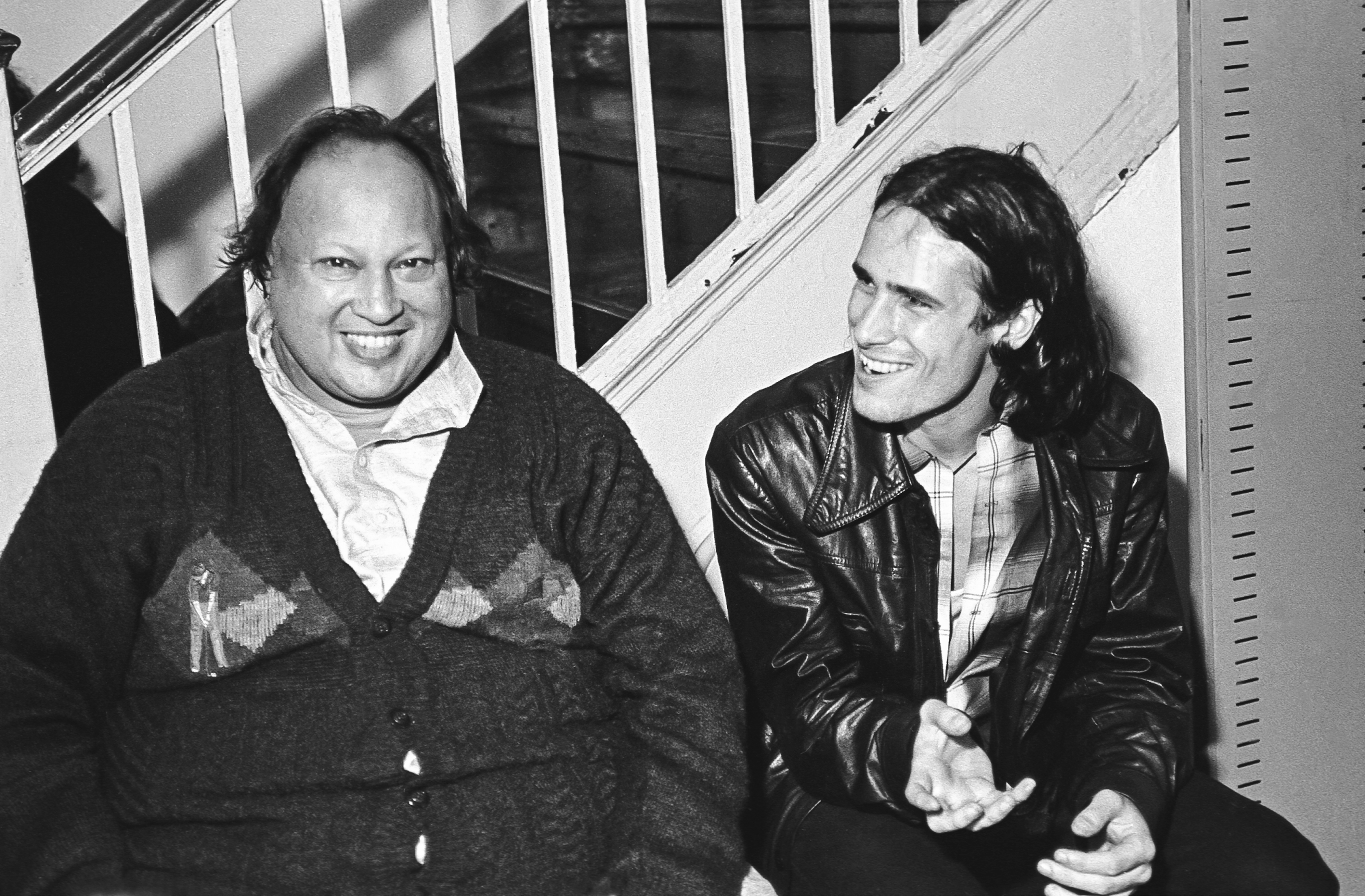 Pakistani musician Nusrat Fateh Ali Khan (1948 - 1997) (left) shares a laugh with American musician Jeff Buckley
