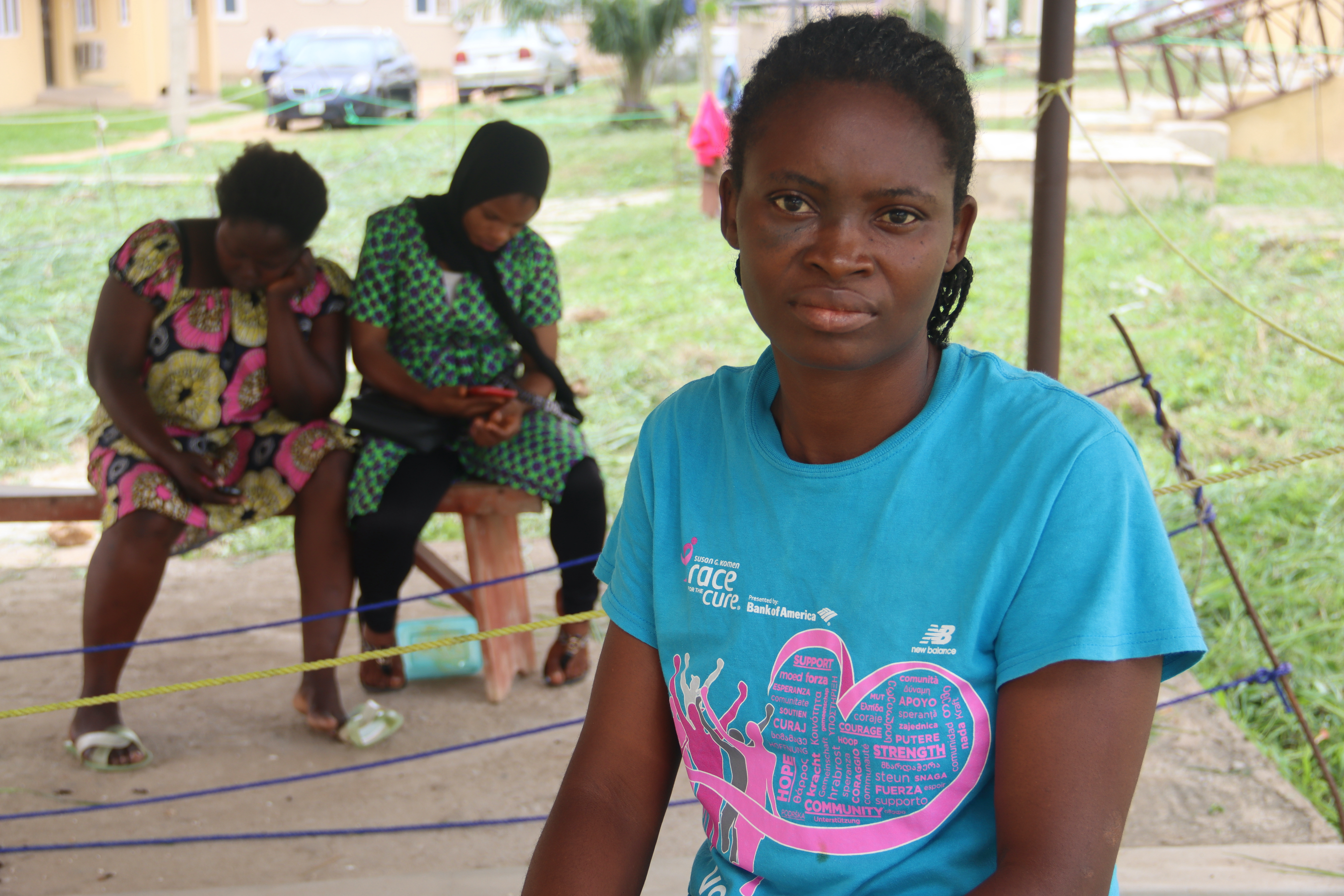 Mrs Kayode, a main character, in the patient area of ​​the family visitor's room, a lean-to under which a ditch separates the sick from the healthy
