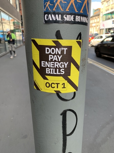 A sticker on a pole in Manchester, UK, protesting rising energy bills.