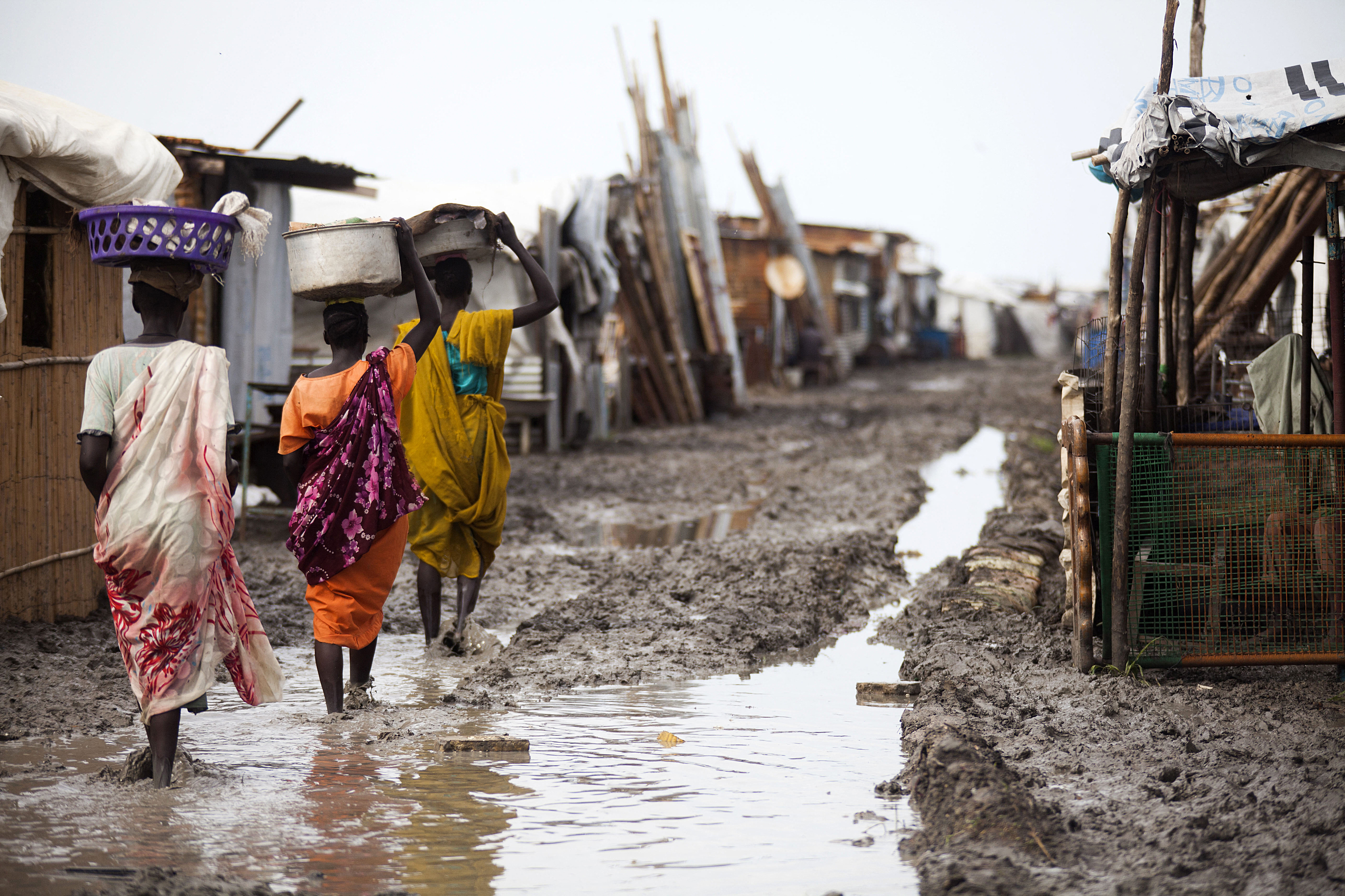 Women carry their belongings inside the Protection of Civilians (PoC) site in Malakal, on June 14, 2016