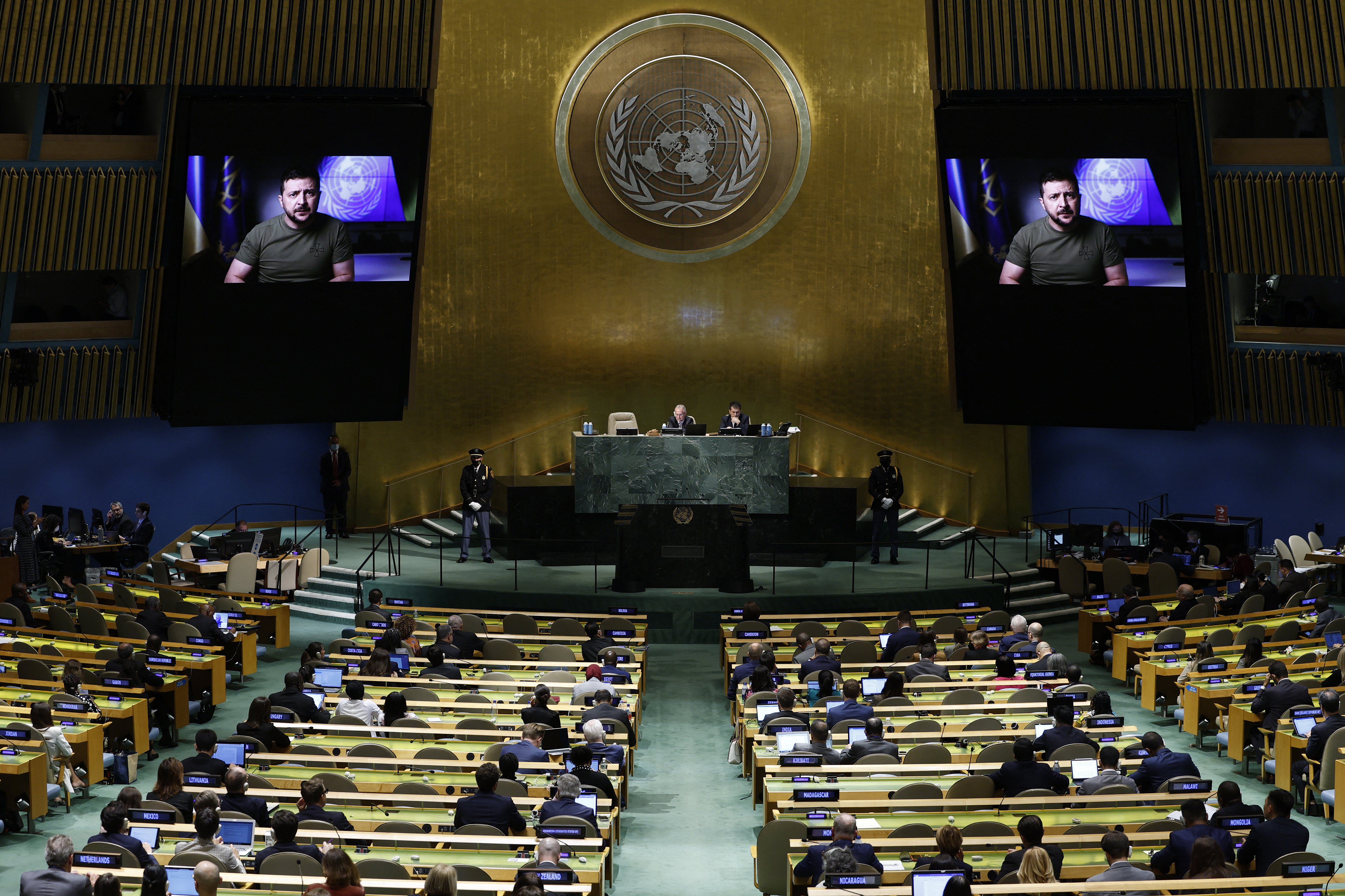 Delegates watch a pre-recorded speech by Ukrainian President Volodymyr Zelenskyy on two large screens on each side of the auditorium during the 77th session of the United Nations General Assembly.