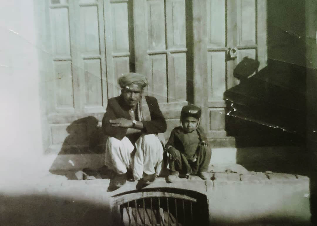 A photo of a man sitting next to a child.