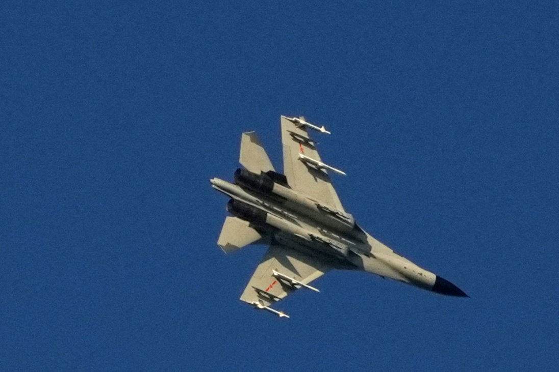 A Chinese People's Liberation Army (PLA) aircraft flies over the 68-nautical-mile scenic spot, one of mainland China's closest points to the island of Taiwan.