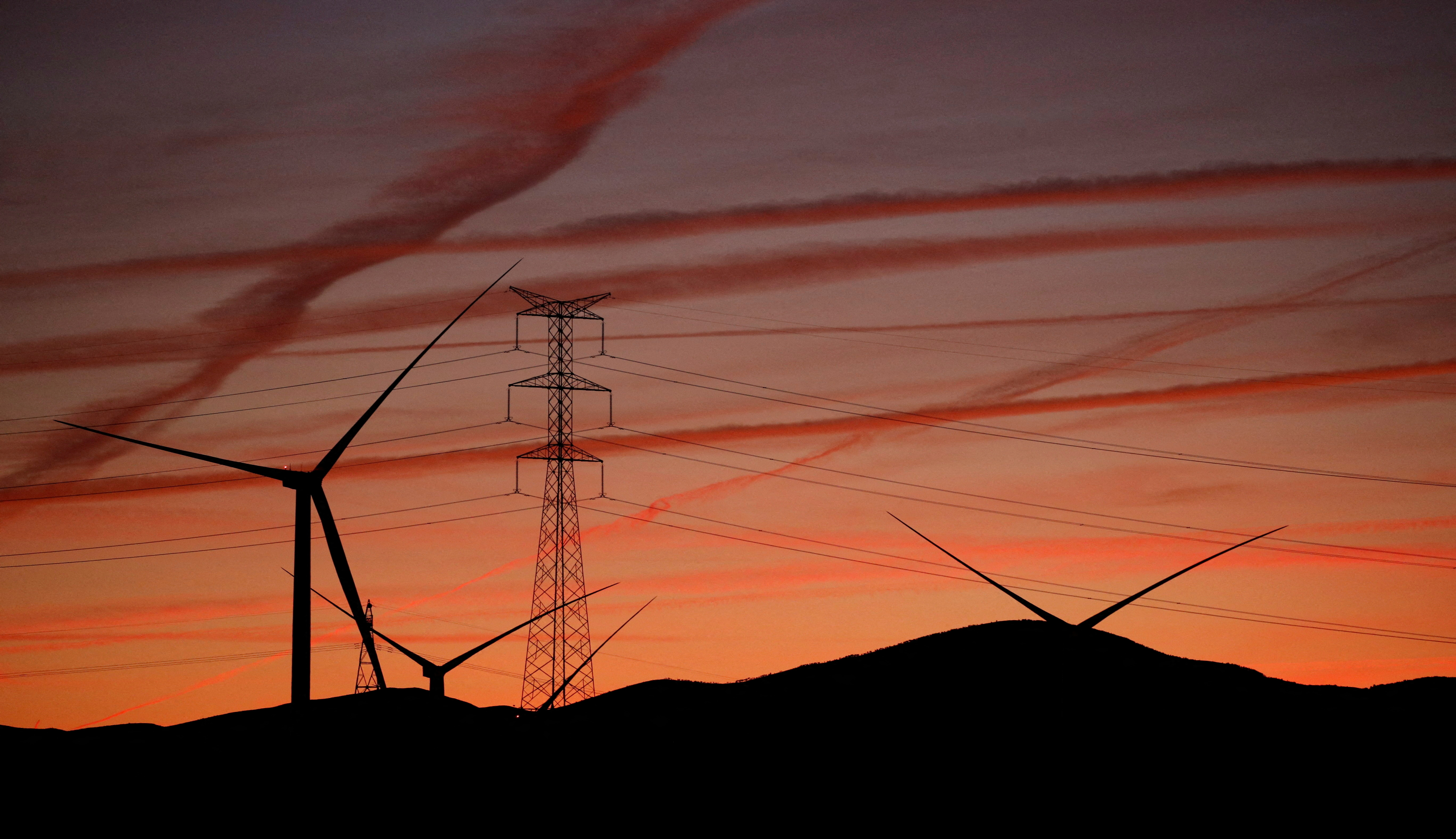 High-voltage power lines, an electricity pylon and wind turbines are seen near Pedrola, Spain, December 12, 2021. Picture taken on December 12, 2021.