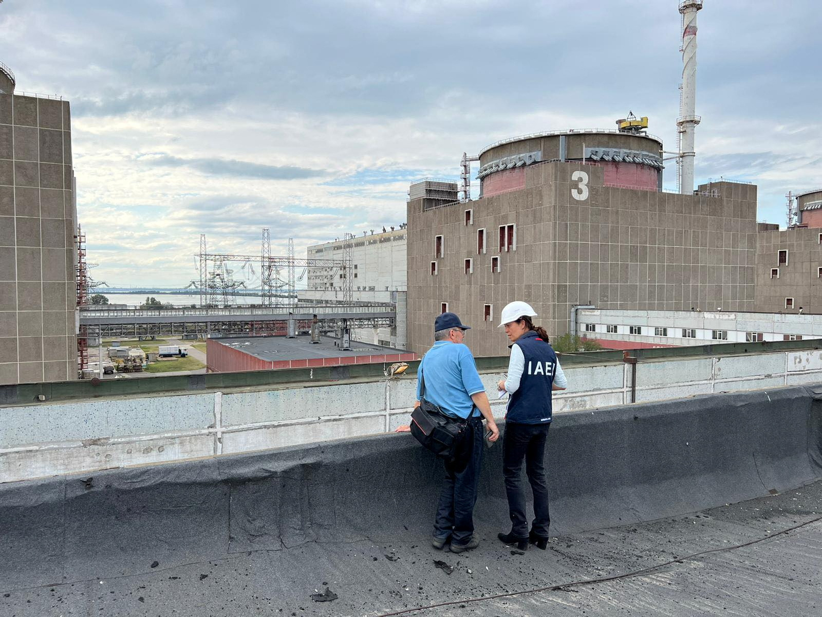 An International Atomic Energy Agency (IAEA) expert on the roof of a building outside the Zaporizhzhia nuclear plant in Ukraine.