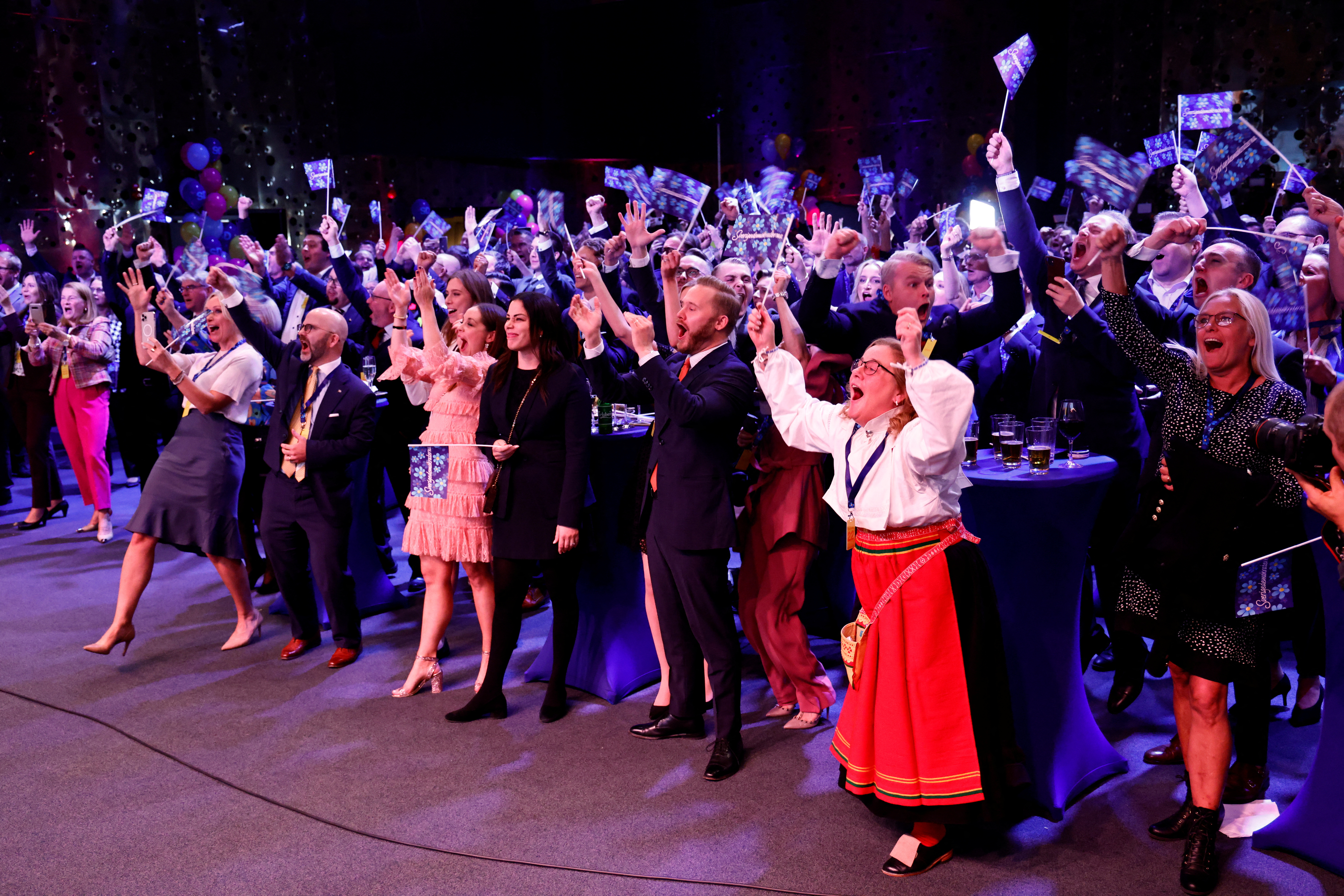 Supporters of the Sweden Democrats react on the results of the exit polls at the Party's election watch at the Elite Hotel Marina Tower in Nacka, near Stockholm, Sweden, September 11, 2022. [TT News Agency/Stefan Jerrevang via REUTERS]