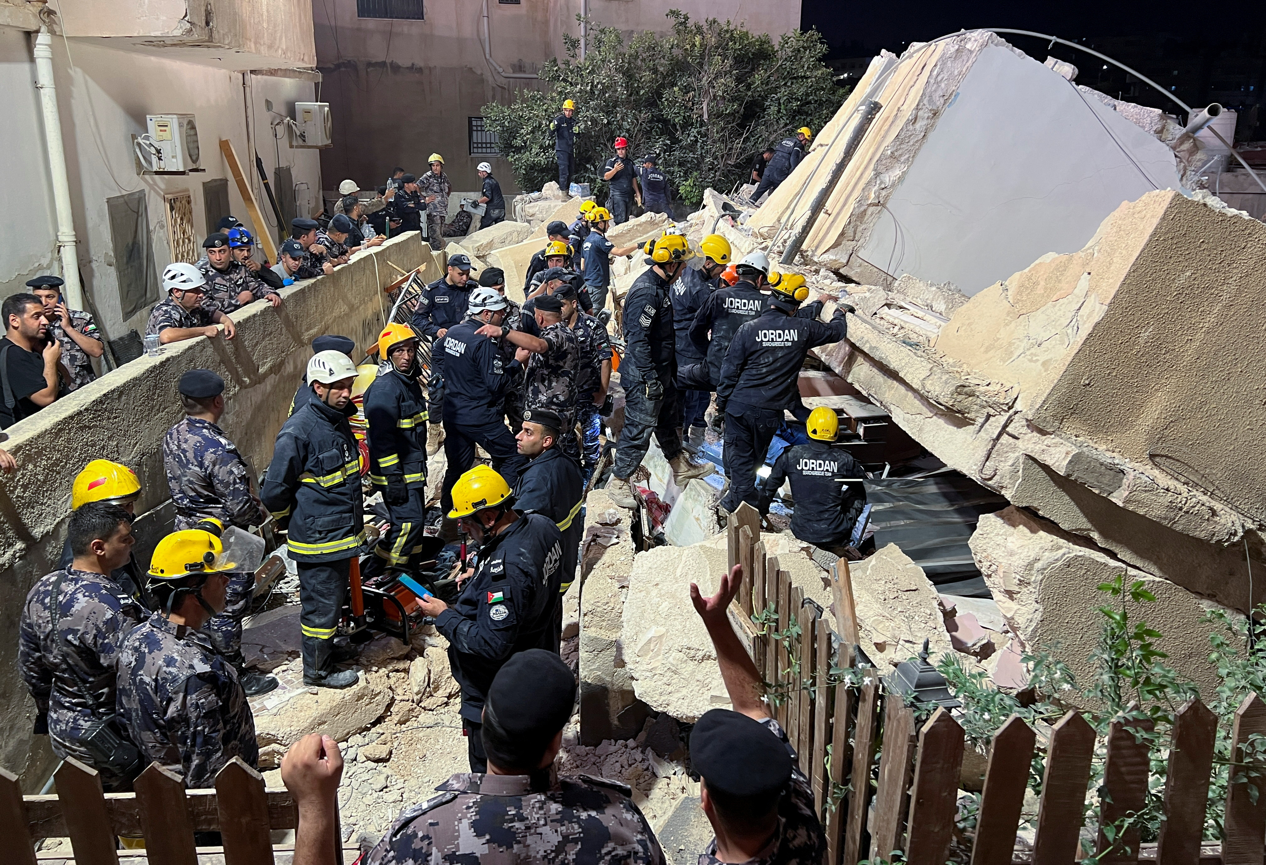 Civil defence members work at the site of a four-storey residential building collapse in Amman, Jordan September 13, 2022.