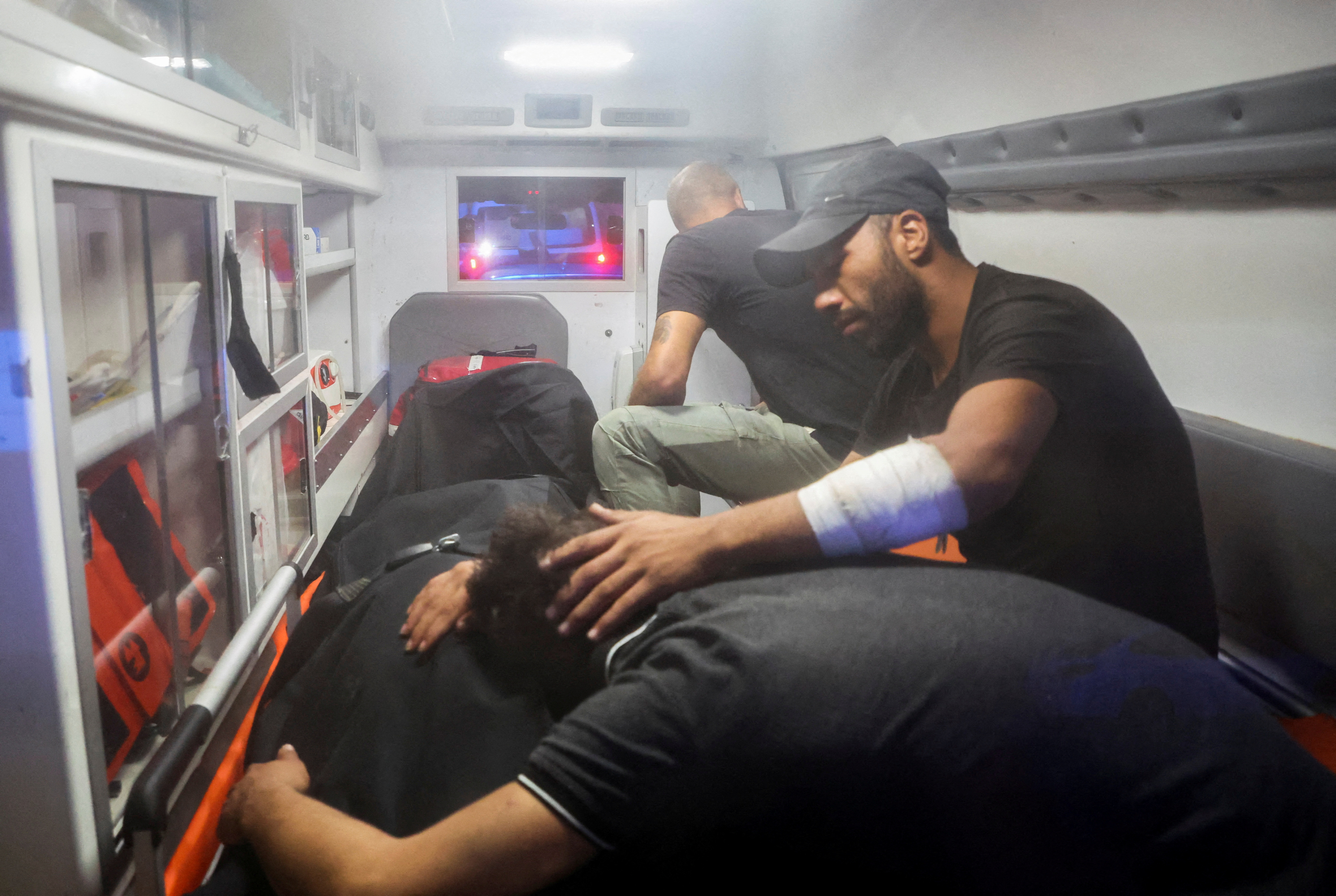 A relative of a man, who was aboard the migrant boat, reacts near his body.