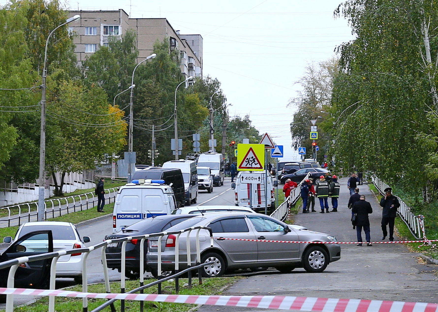 Police and members of emergency services work near the scene of a school shooting.