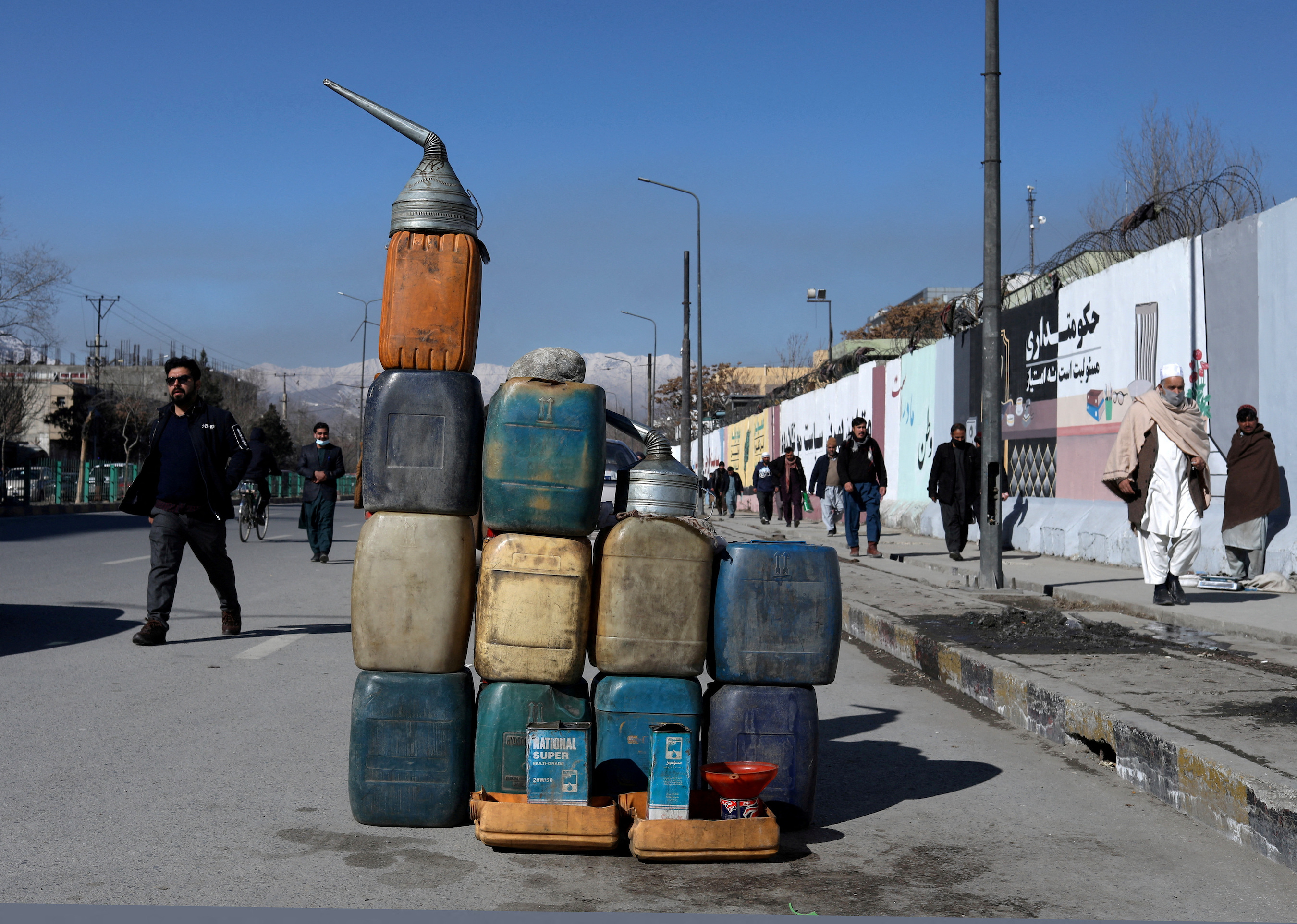 Cans containing gasoline are kept for sale on a road in Kabul, Afghanistan.