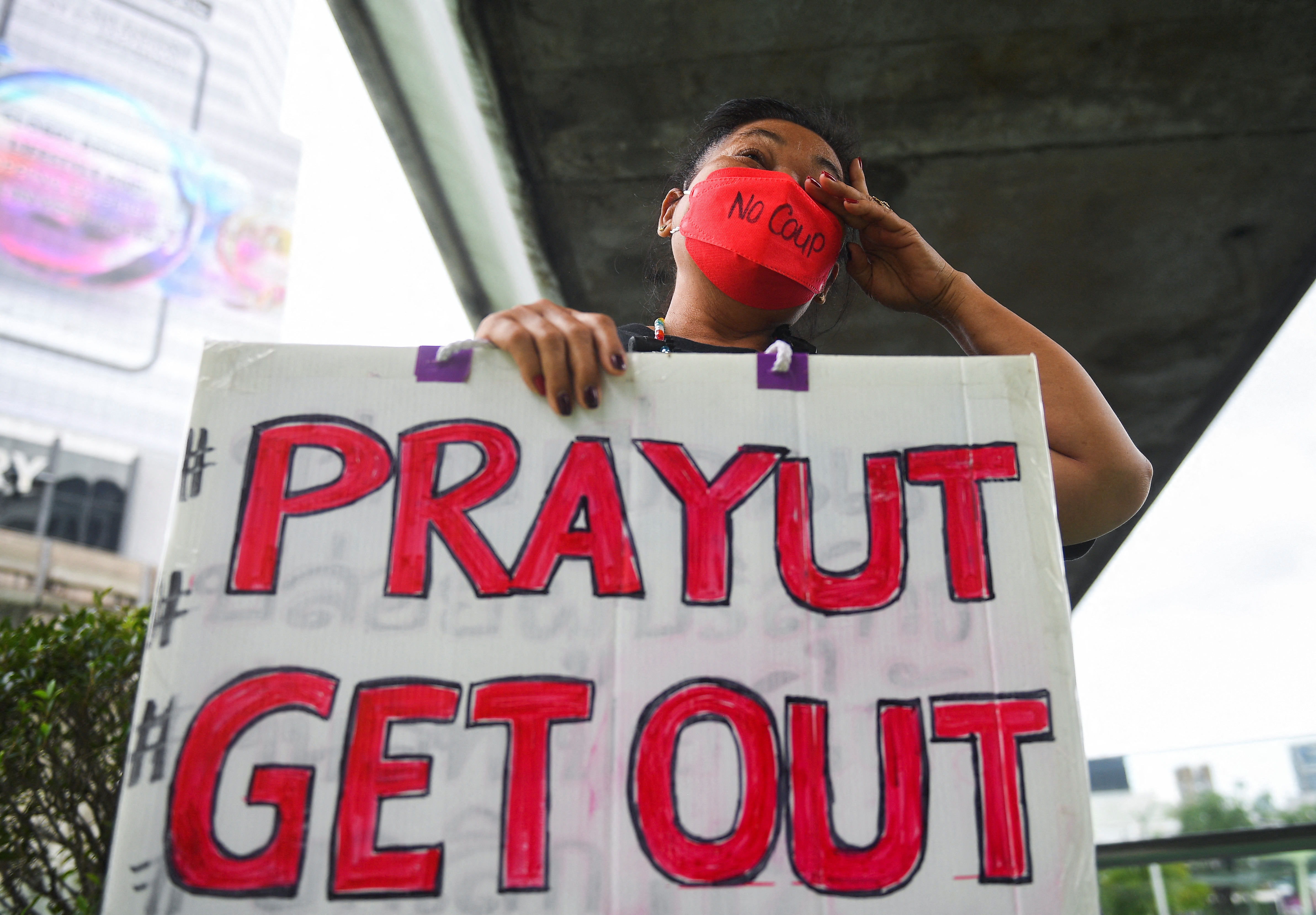 A demonstrator protests as Thailand's Constitutional Court delivers its verdict on Prime Minister Prayuth Chan-ocha's tenure, in Bangkok, Thailand, on September 30, 2022 [Chalinee Thirasupa/Reuters]