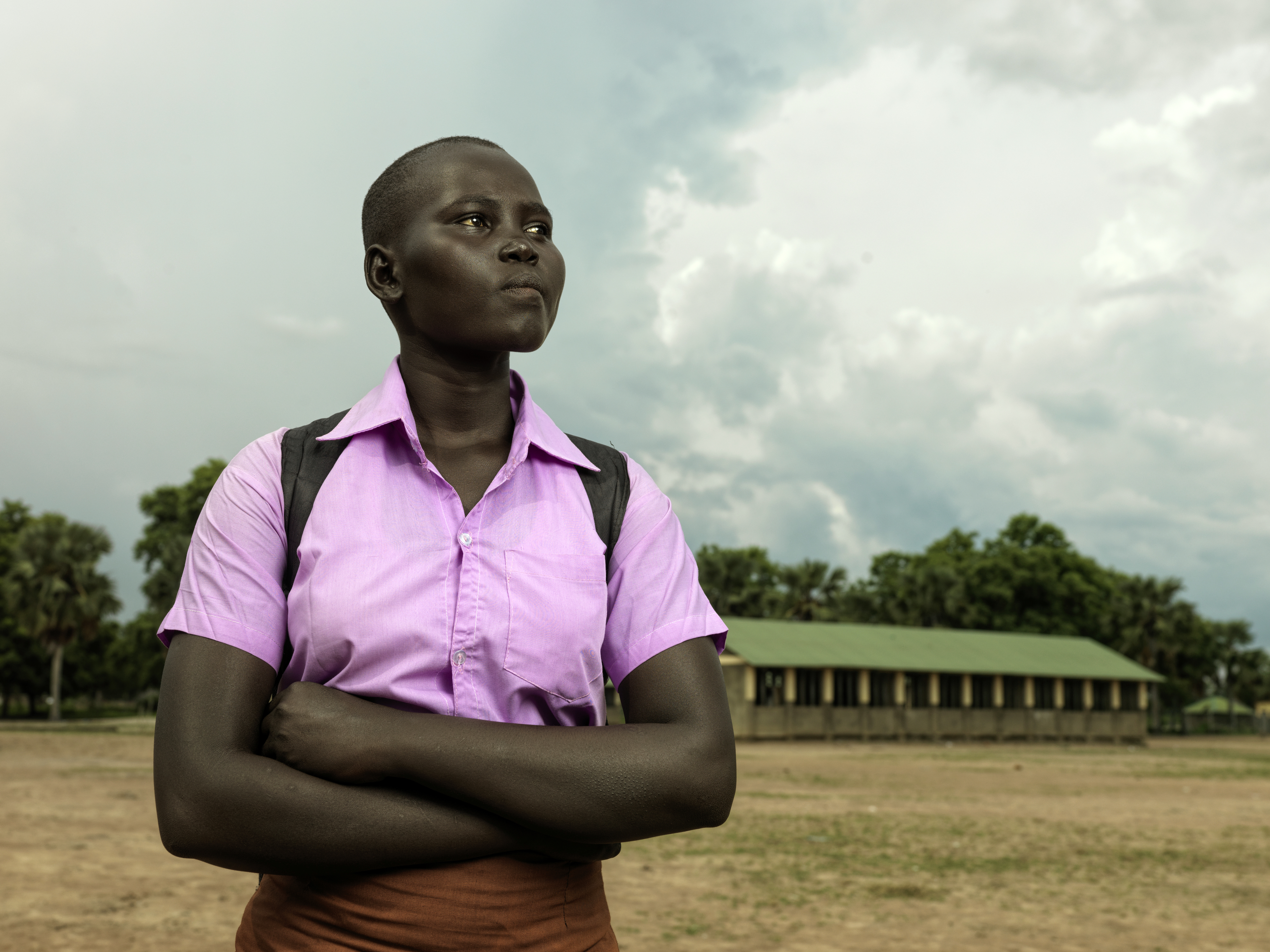 A photo of Hellena standing outside with a building in the background.