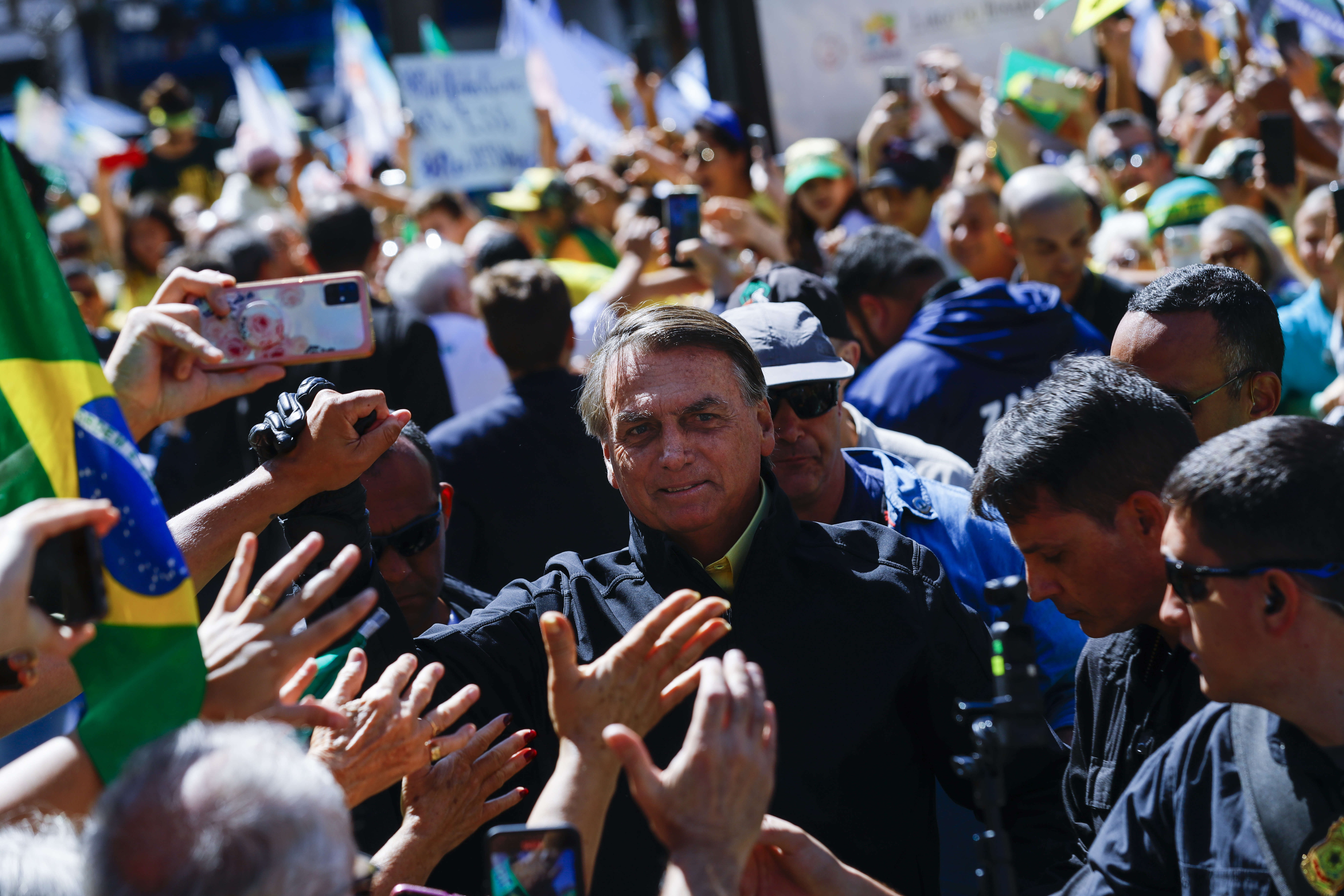 Brazil's President Jair Bolsonaro, who is running for re-election, greets supporters at a campaign event in Campinas, Sao Paulo state, Brazil, Saturday, Sept. 24, 2022. Brazilians head to the polls to elect a president on Oct. 2. (AP Photo/Marcelo Chello)