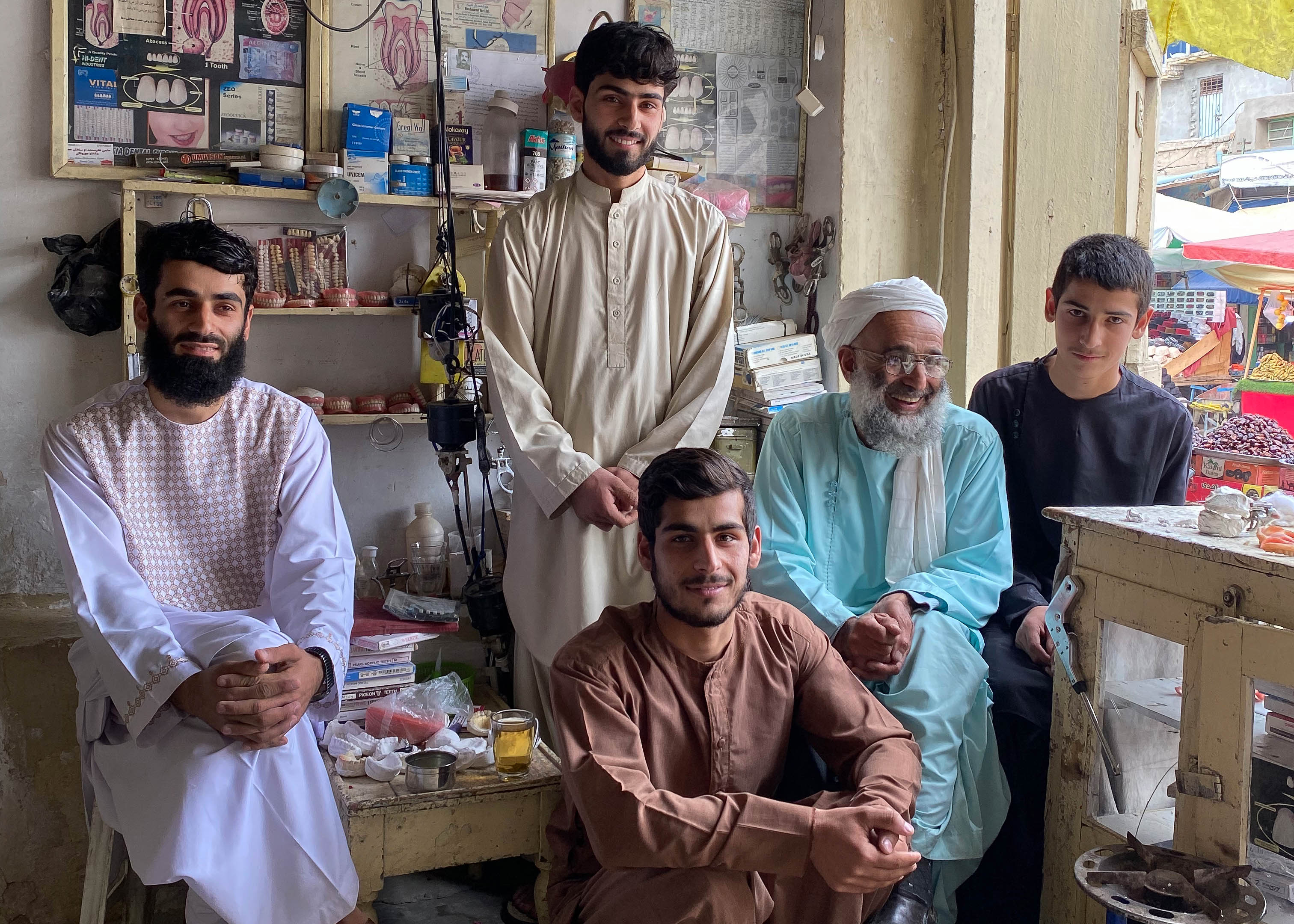 A photo of Haji Muhammad Sultan and his four sons standing around him.