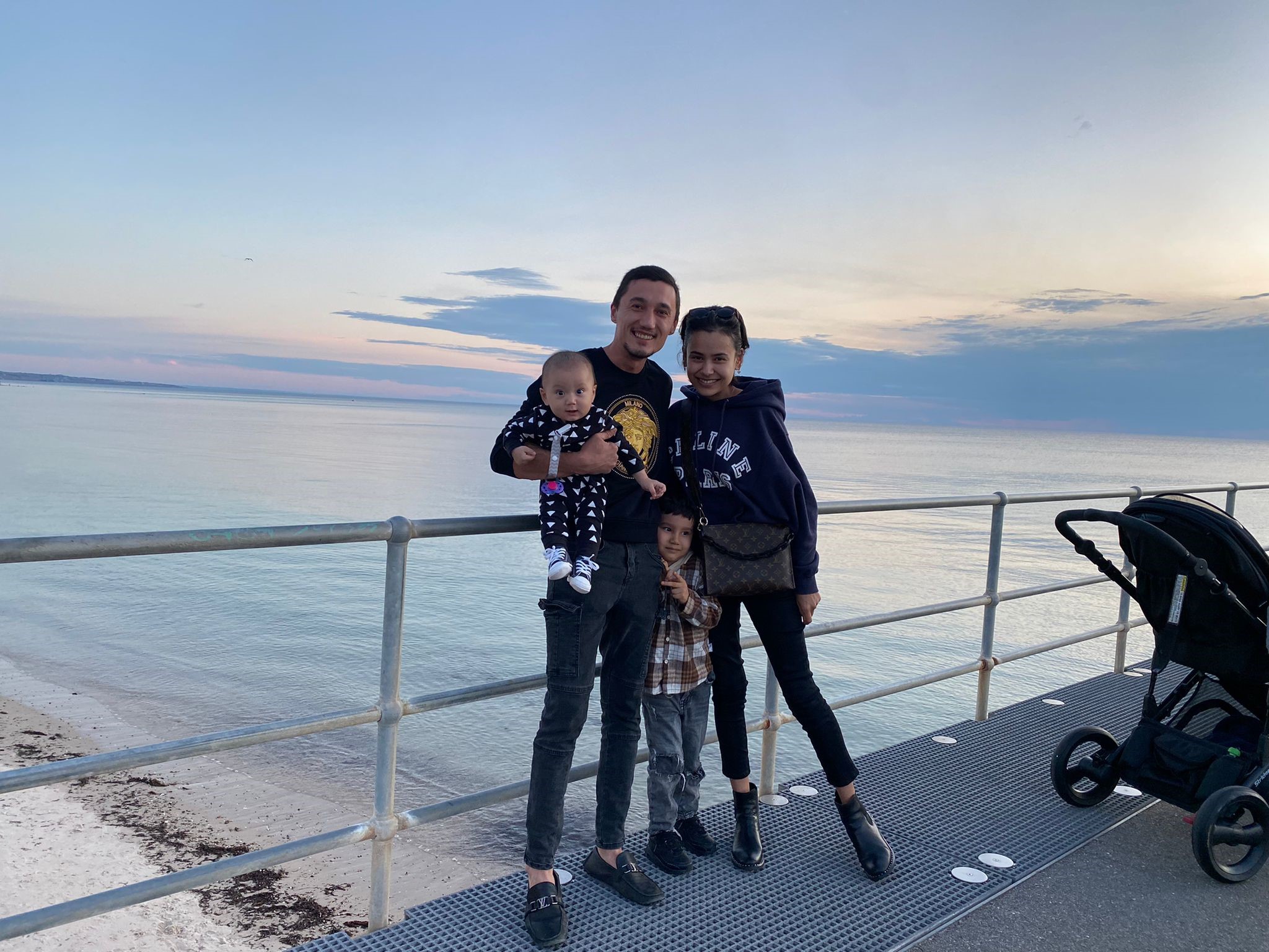 Sadam Abdusalam with his wife and two sons by the sea in Australia