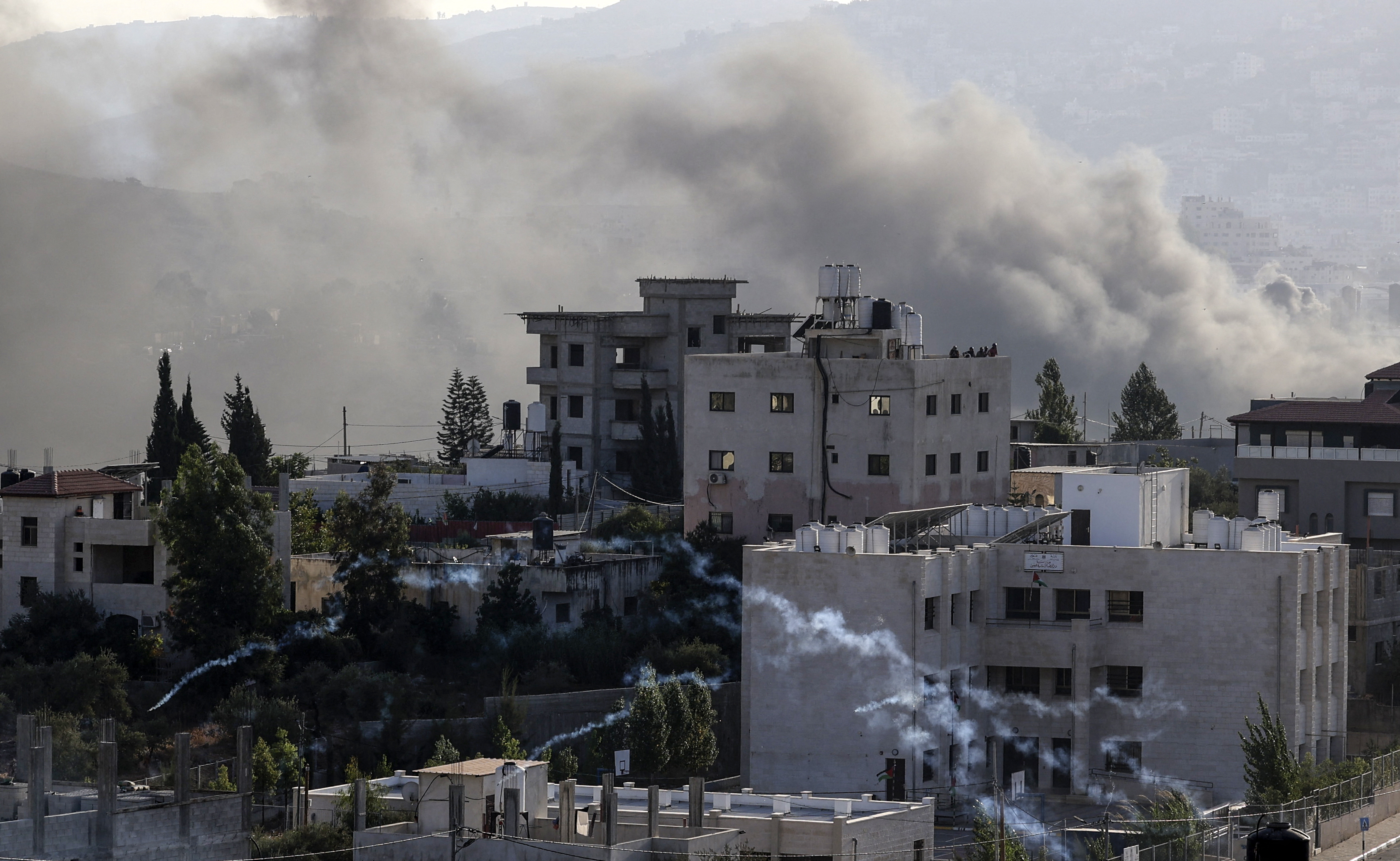 Smoke rises in the West Bank village of Deir al-Hatab east of Nablus, during ongoing confrontations between Palestinians and Israeli security forces