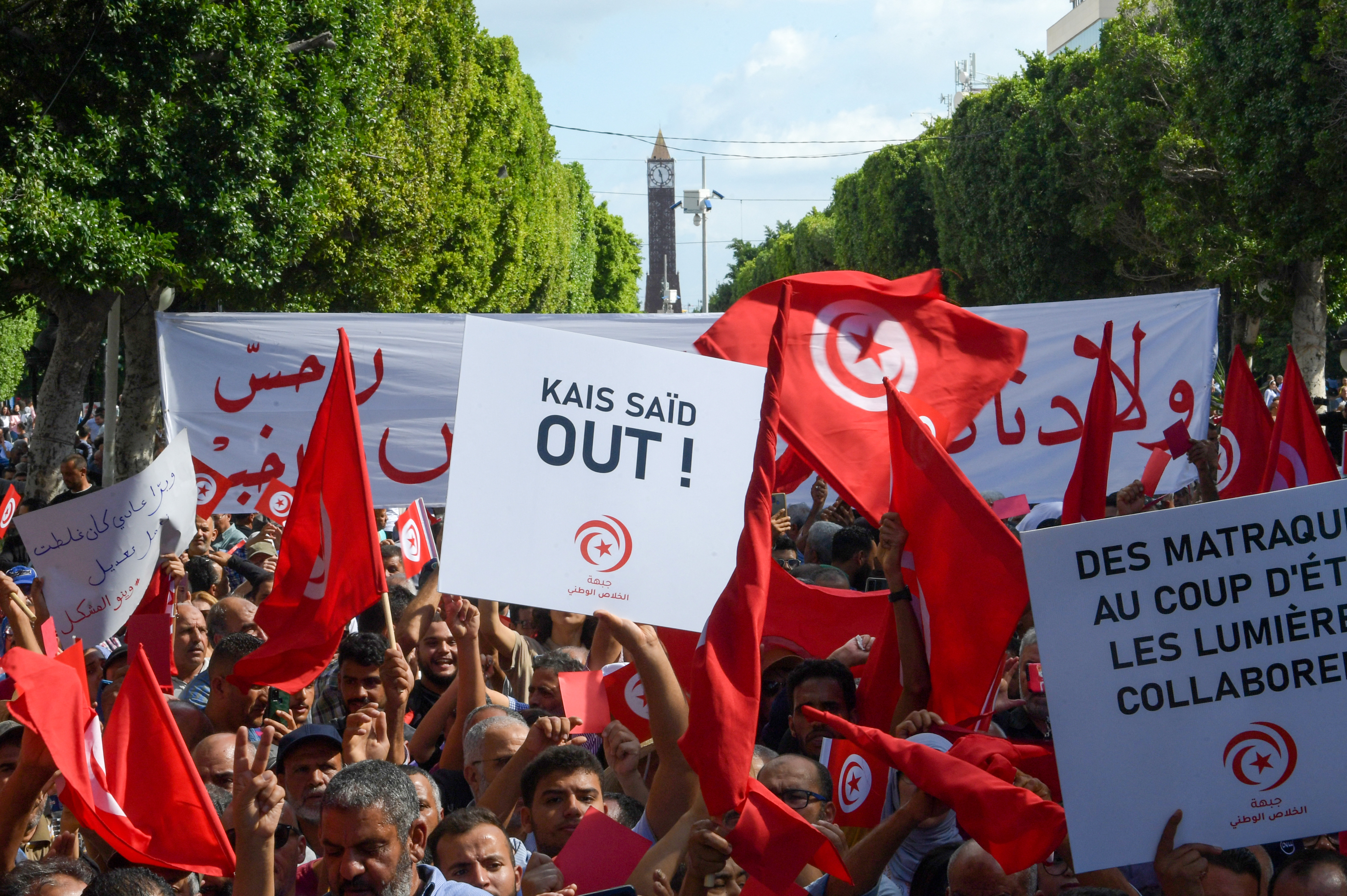Islamist Ennahda party supporters wave the national flag during a demonstration against Pesident Kais Saied in the capital Tunis on October 15, 2022. (Photo by Fethi Belaid / AFP)