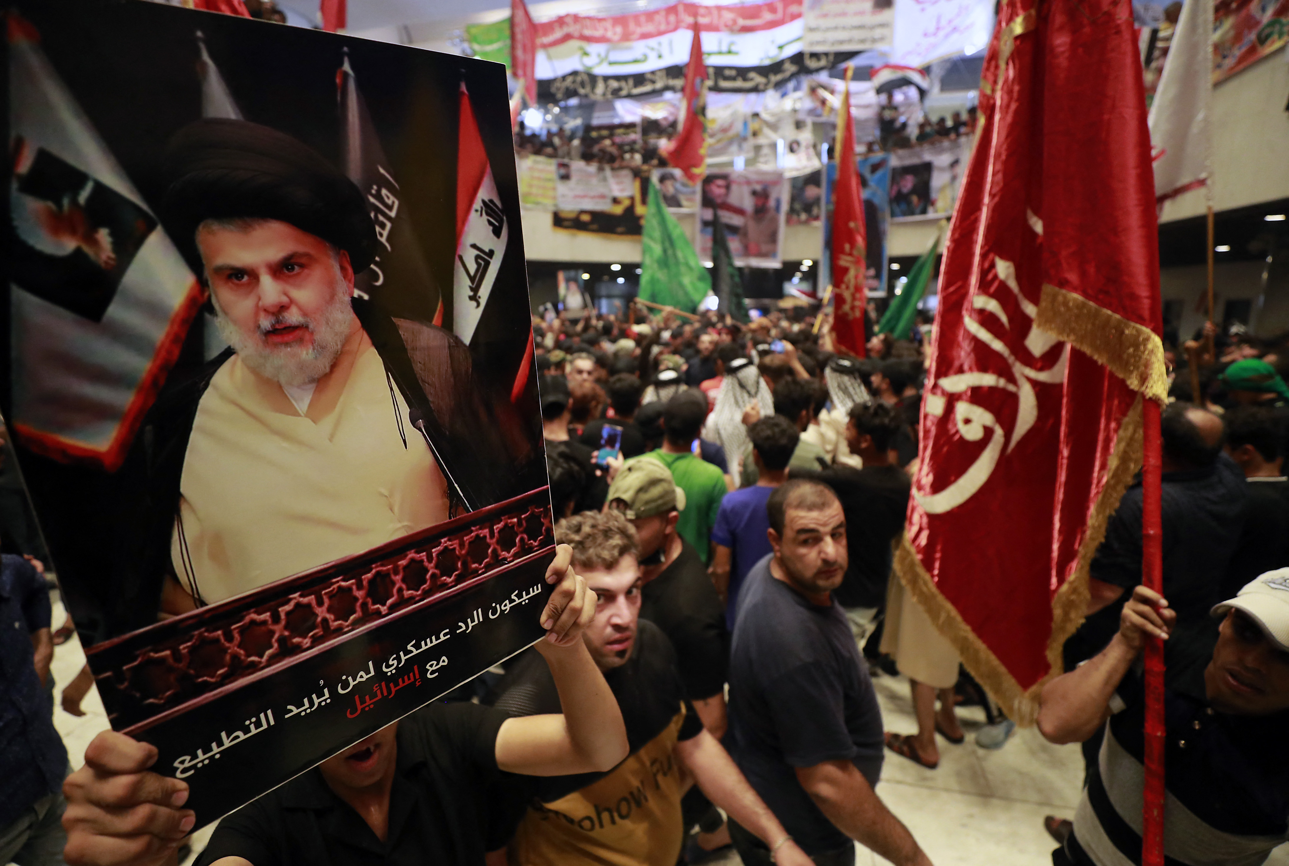 (FILES) In this file photo taken on August 2, 2022, supporters of Iraqi cleric Moqtada Sadr (image), protest against a rival bloc's nomination for prime minister, in the capital Baghdad's high-security Green Zone. - The movement led by firebrand cleric Moqtada Sadr announced today its refusal to be part of the upcoming government set to be formed by Mohammad Shia al-Sudani. (Photo by AHMAD AL-RUBAYE / AFP)