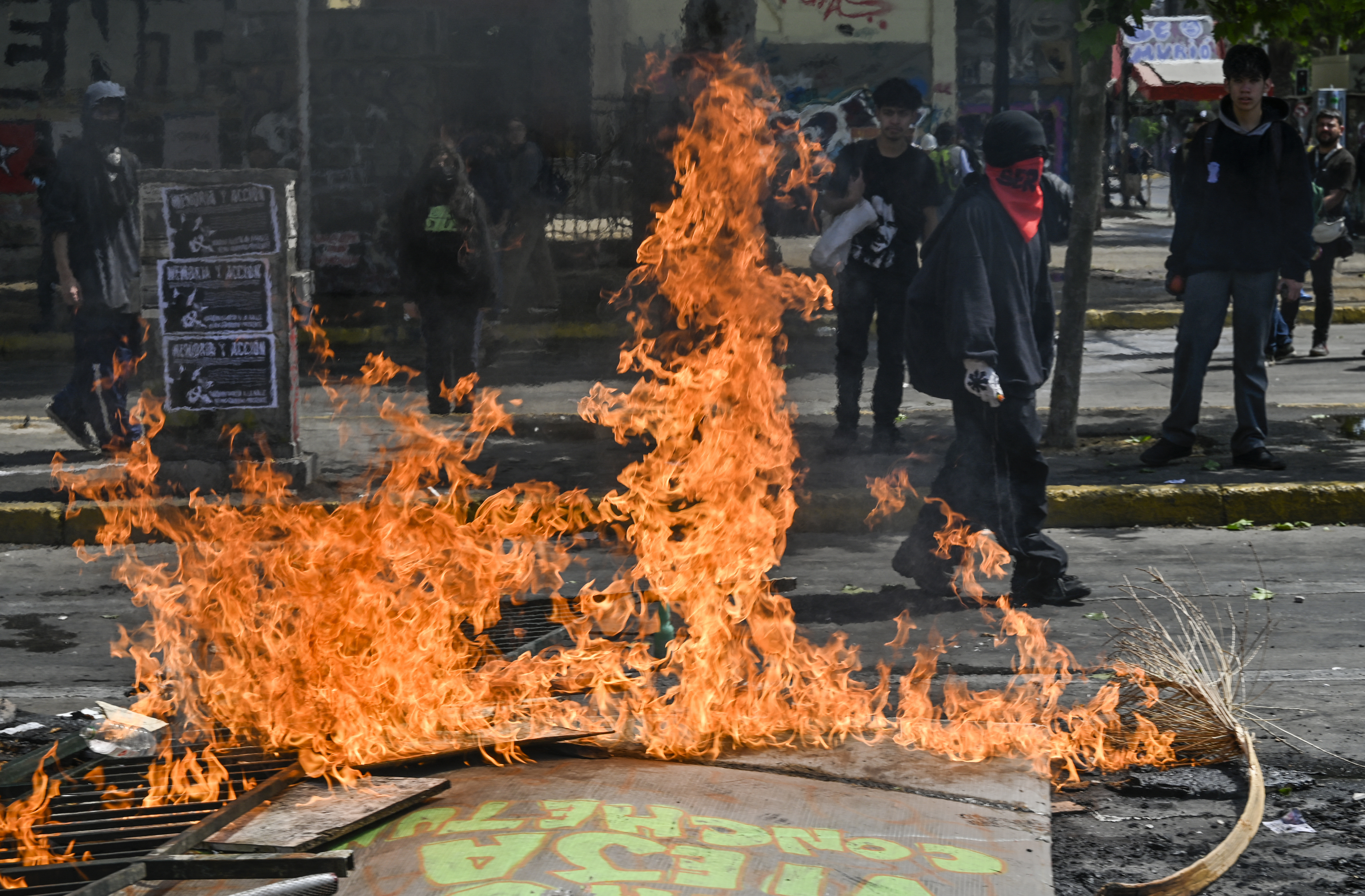 Street with barricade lying on the ground in flames 