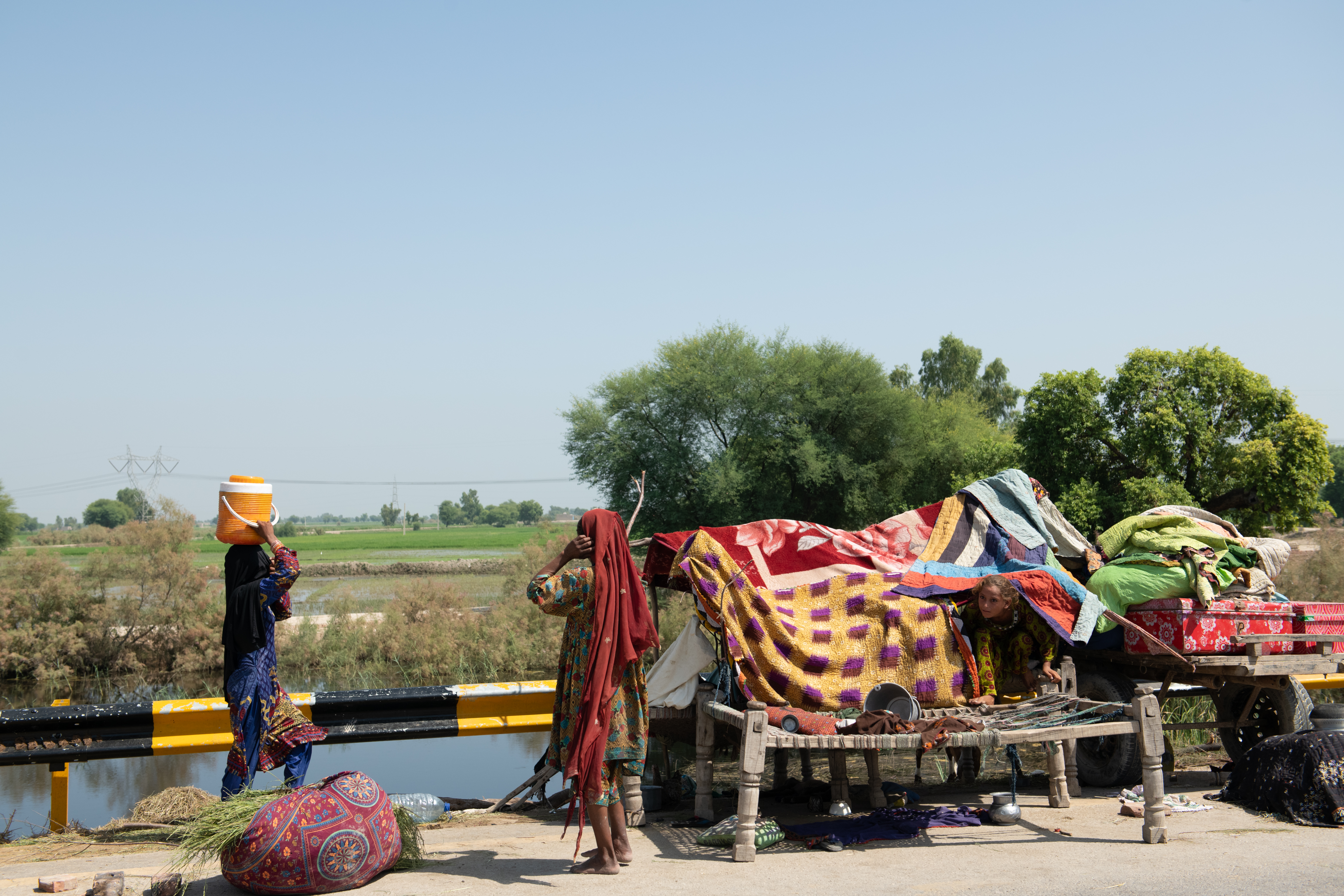 A young girl carries her family's supply of drinking water on her head. When disasters like this occur, the burden of labour on women and girls increases tremendously.