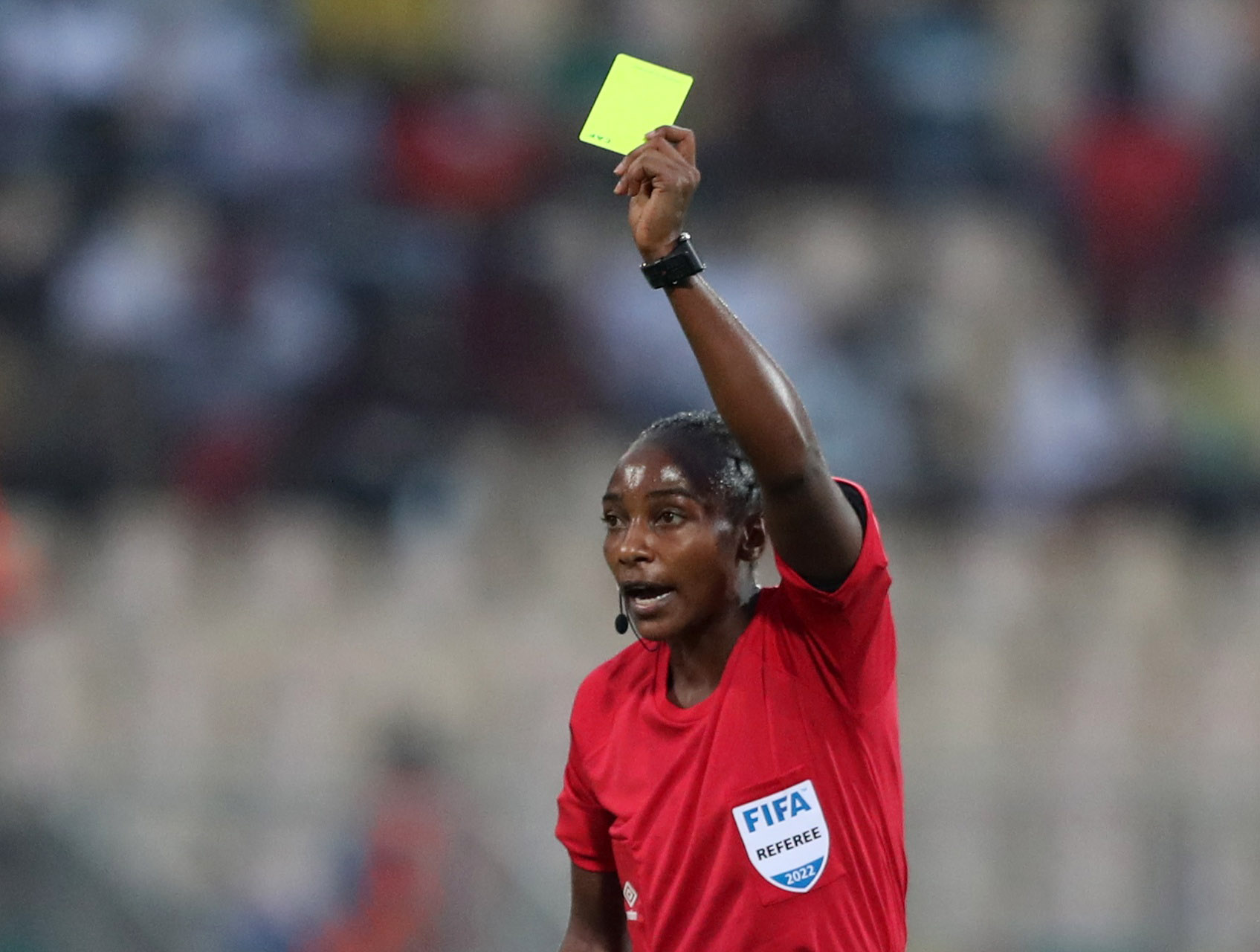 Soccer Football - Africa Cup of Nations - Group B - Zimbabwe v Guinea - Stade Ahmadou Ahidjo, Yaounde, Cameroon - January 18, 2022 Referee Salima Mukansanga shows a yellow card to Zimbabwe's Talbert Shumba REUTERS/Mohamed Abd El Ghany