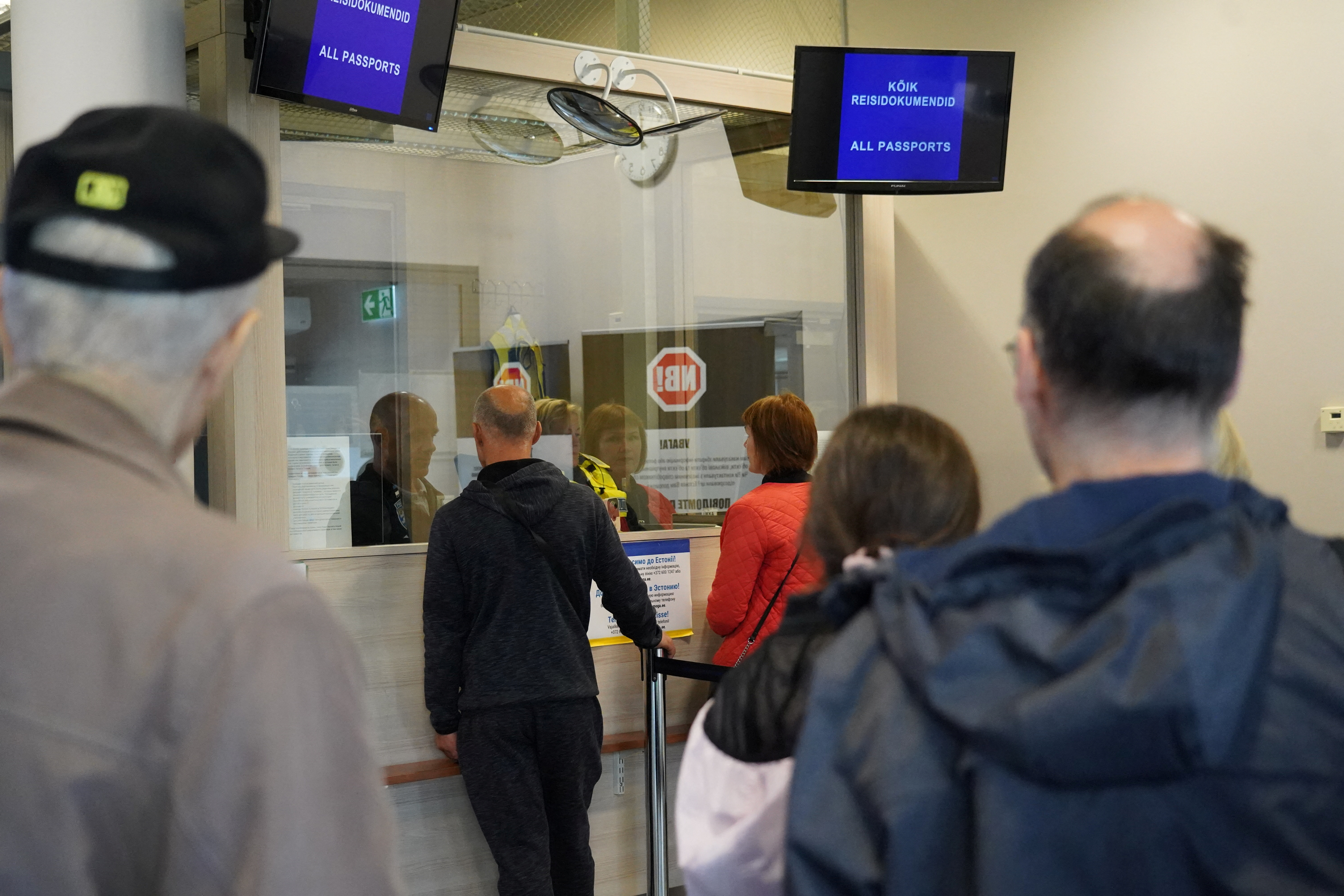 People wait at the border crossing point with Russia in Narva, Estonia on September 18, 2022