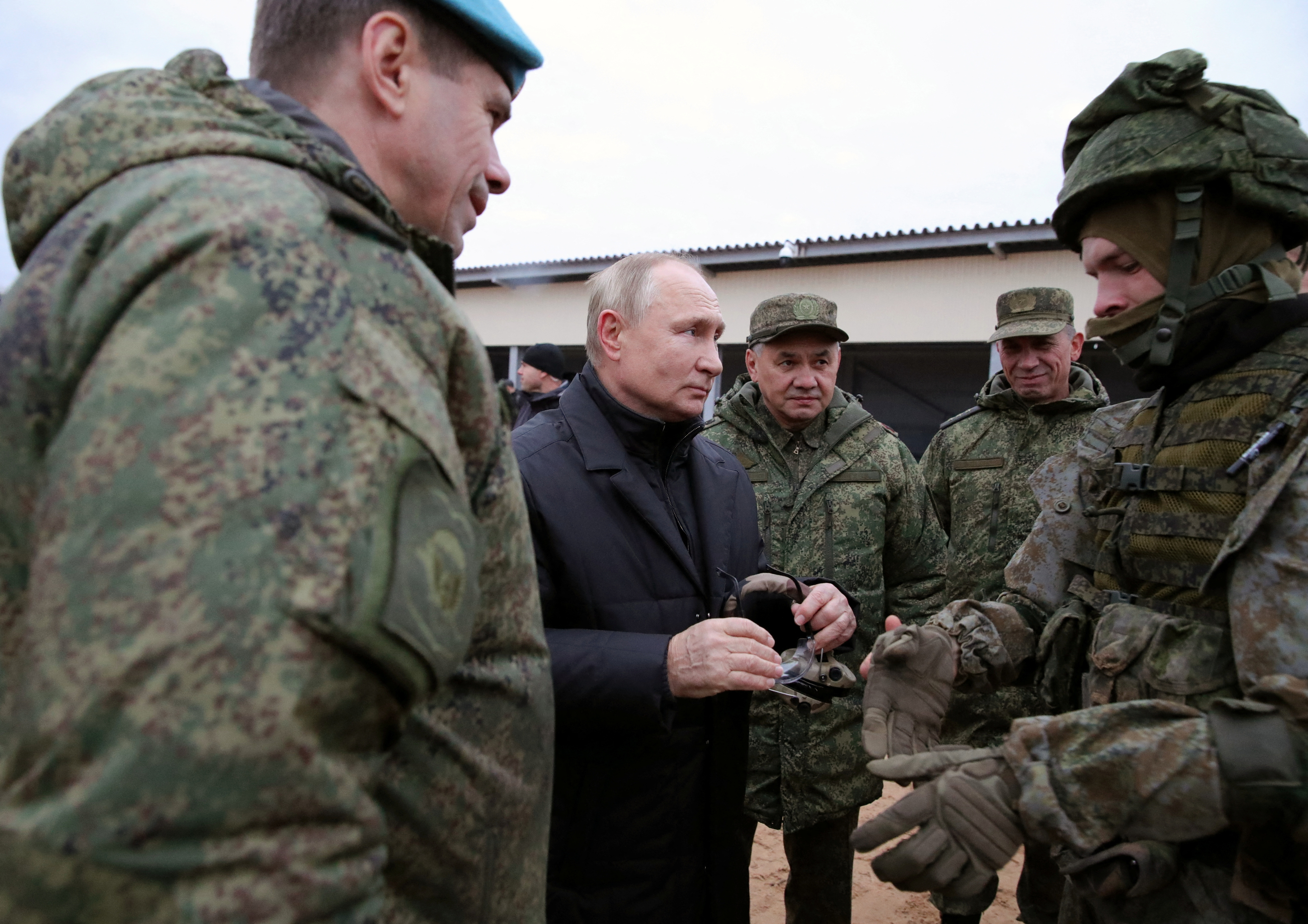 Russian President Vladimir Putin visits a training centre of the Western Military District for mobilised reservists along with Defence Minister Sergei Shoigu (3-L) and Deputy Commander of the Airborne Troops Anatoly Kontsevoy (1-L), in Ryazan Region, Russia October 20,