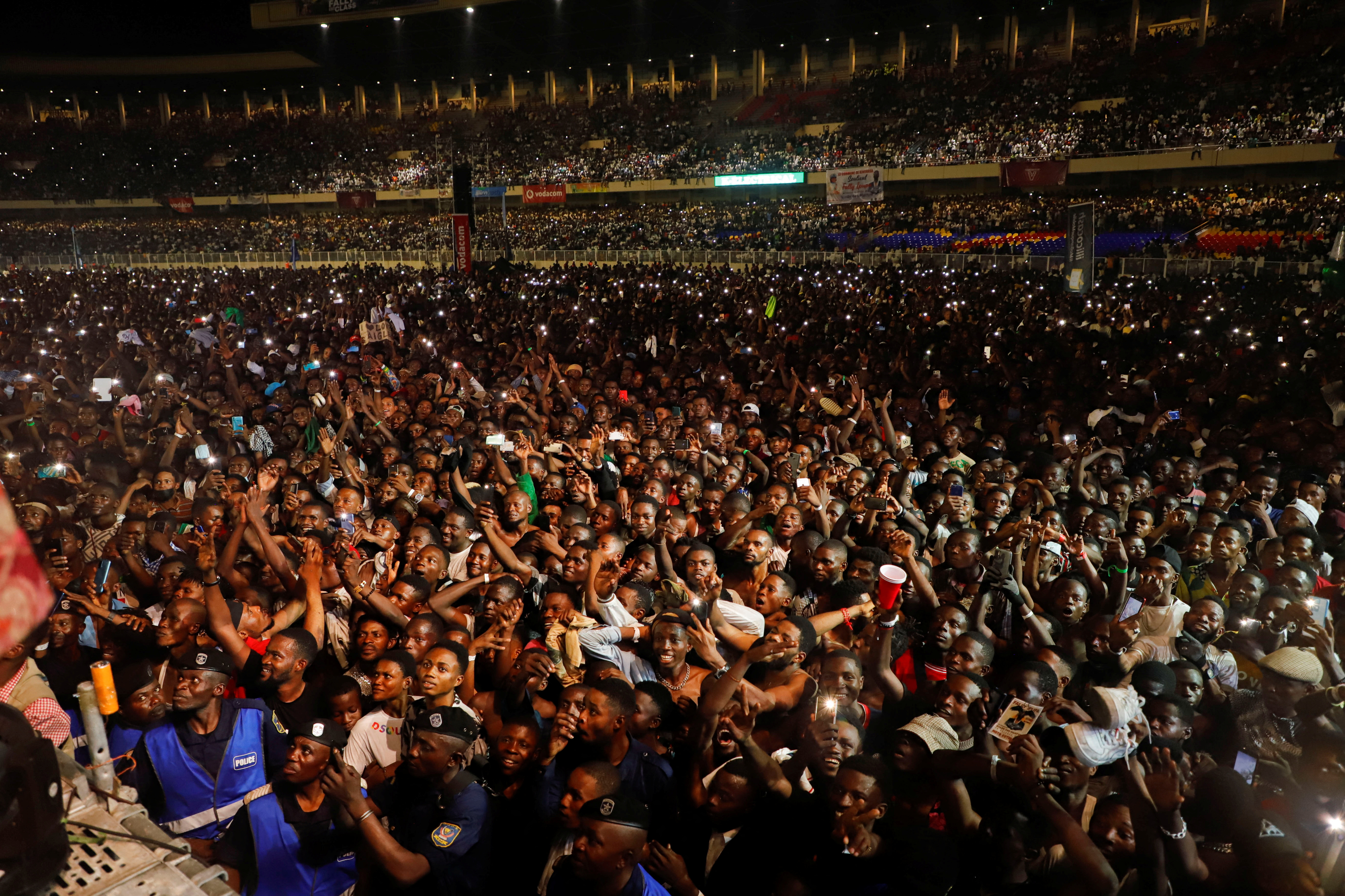 People gather at the concert of the Congolese singer Fally Ipupa, where people were killed, including police officers, in a crush at the overcrowded Martyrs stadium in Kinshasa, Democratic Republic of Congo